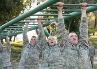 Trainees from basic military training navigate a water obstacle during Warrior Week. Changes were made to the basic military training curriculum in November 2005 that focused more on instilling war skills and strengthening the warrior ethos in Airmen graduating from training. BMT is scheduled to lengthen by two weeks next month, beginning with trainees arriving Nov. 4. (USAF photo by Robbin Cresswell)