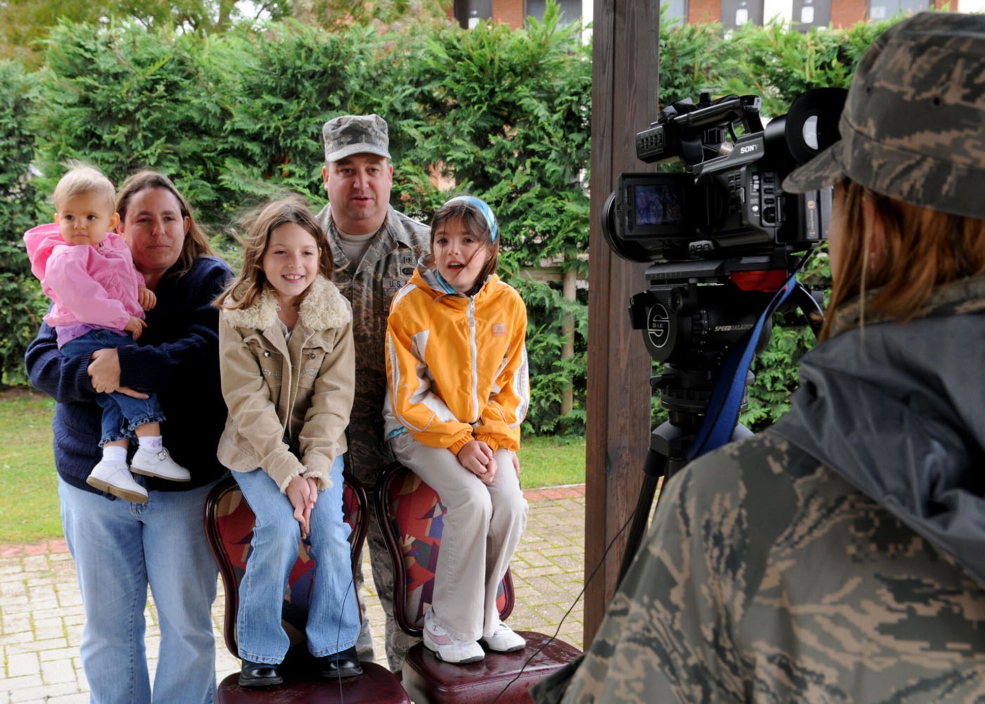 Staff Sgt. Alana Ingram, Air Force News, videos the Sharp family for the “Hometown Holiday Greetings” program Oct. 3, 2008, at RAF Mildenhall, England. While servicemembers and their families serve their tours overseas, AFNews records and sends taped messages for broadcast on local television stations for families in the states to see during the holiday season. (U.S. Air Force photo by Staff Sgt. Jerry Fleshman)