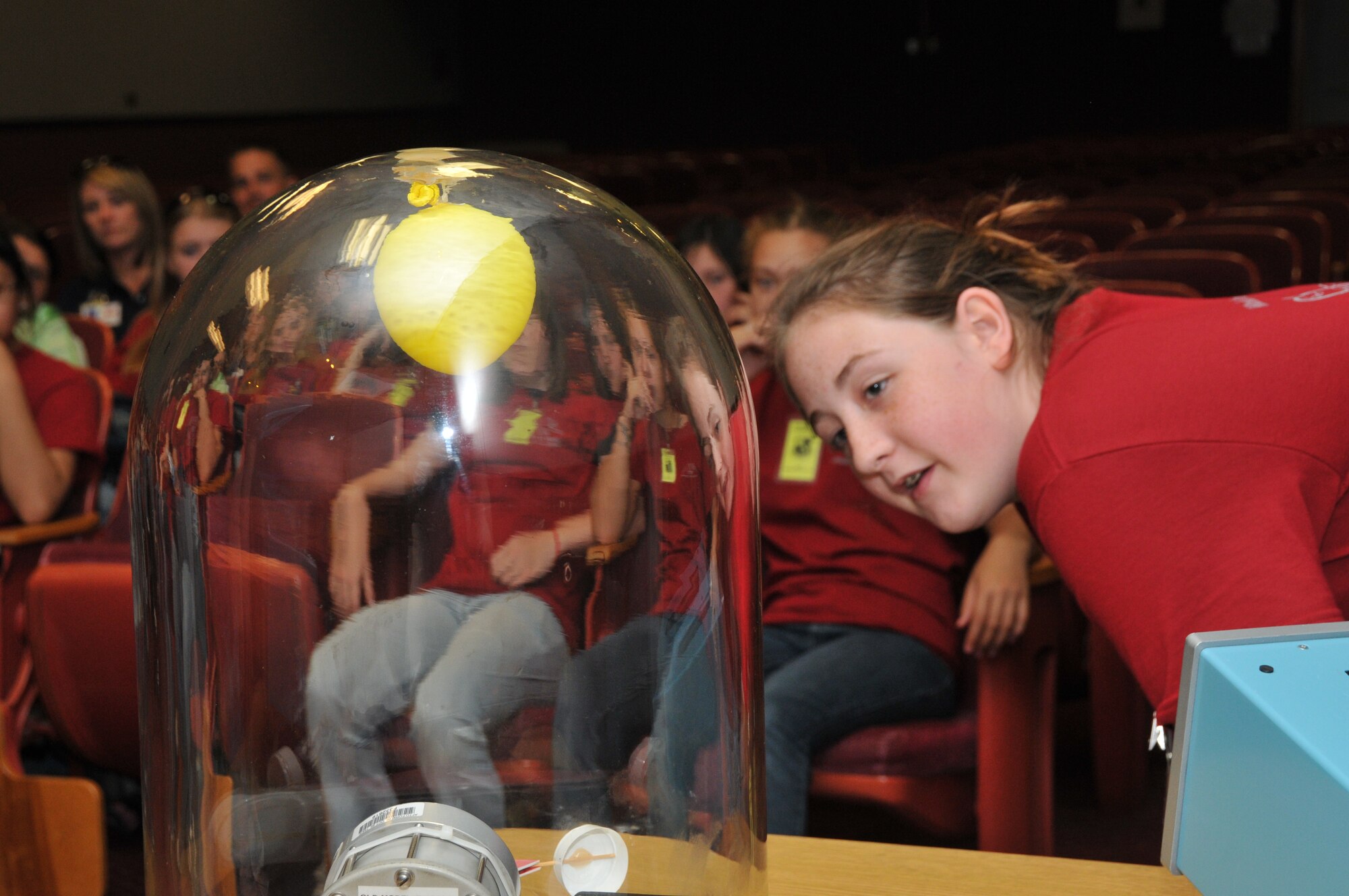 An eighth grader looks at one of the many experiments demonstrated at the Main Auditorium during the two-day tour. (Photo by David Housch)