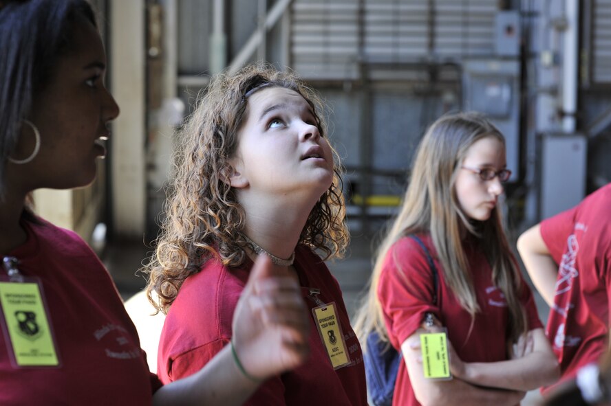 An eighth grader looks in awe as she walks into the test area of the 16-foot supersonic wind tunnel during her tour. (Photo by Rick Goodfriend)