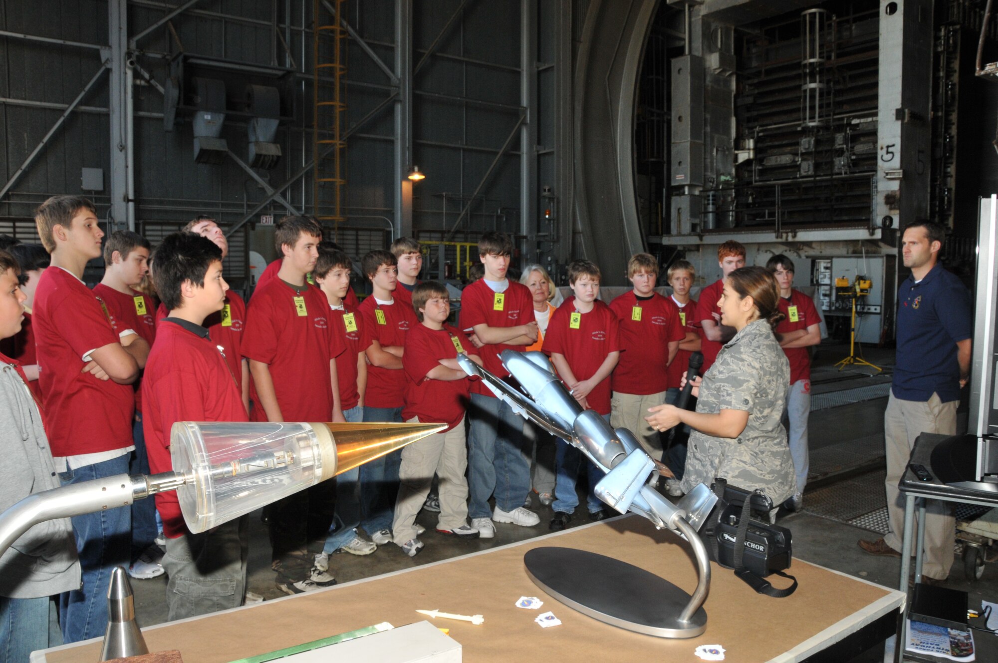 Lt. Col. Vanessa Bond, 716th Test Squadron commander, explains how AEDC tests the models, located on the table, in the center’s wind tunnels. (Photo by David Housch)