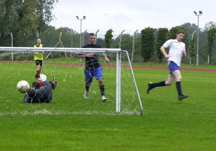 Darren Odey (in white) scores for the 100th Civil Engineer Squadron to tie the game at 1-1 against the 100th Logistics Readiness Squadron during the Wing Sports Day at Heritage Park, Oct. 2. CE won in a penalty shoot-out after the game ended 1-1. (U.S. Air Force photo by Gary Rogers) 