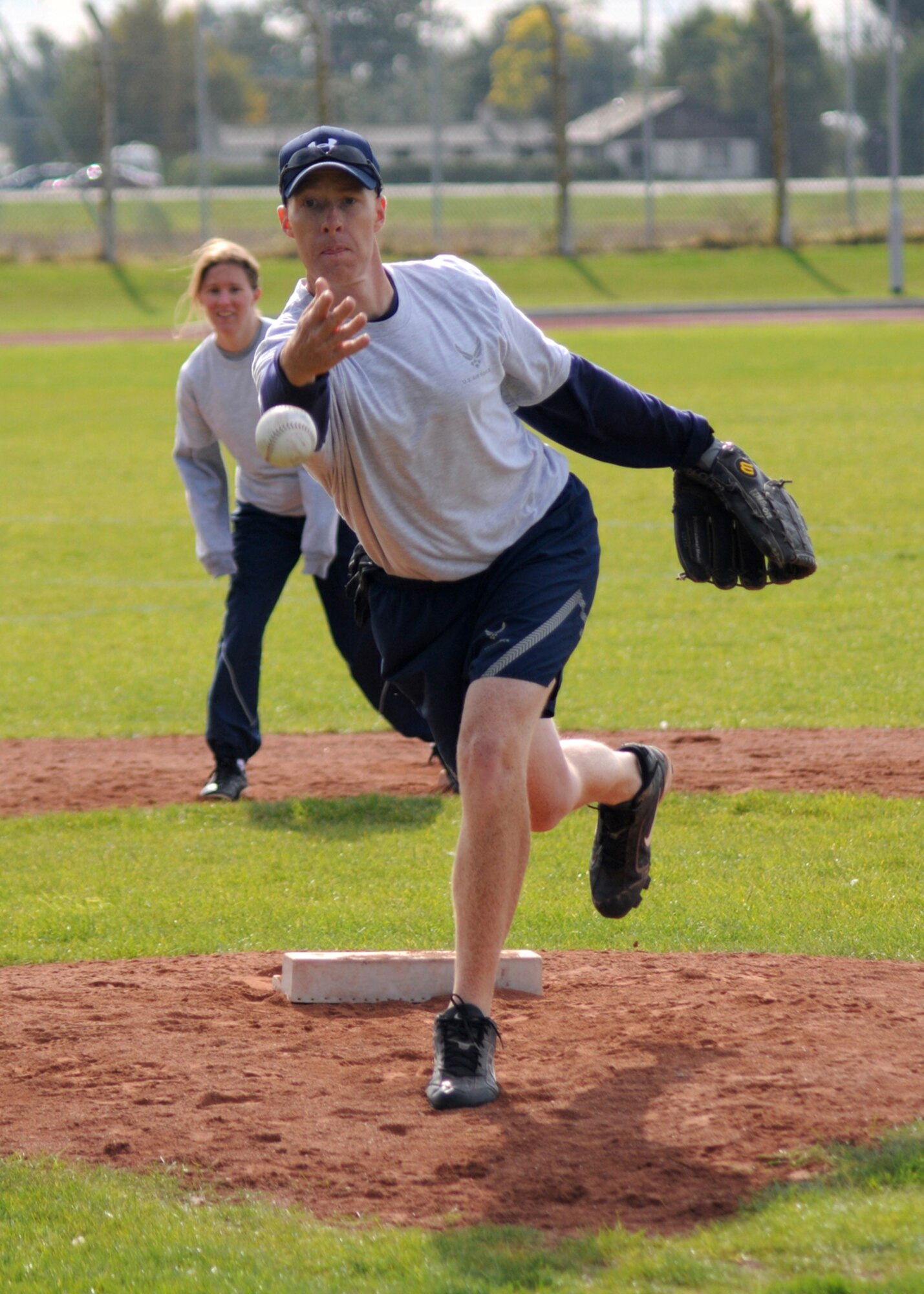 100th Air Refueling Wing Command Chief Master Sgt. Michael Warner delivers a pitch in a softball game during “Wing Sports Day” Oct. 2, at RAF Mildenhall. Wing Sports Day is a day of fun and friendly competition, where Airmen from their respective work centers work together to compete for the top spot and a year’s worth of bragging rights. (U.S. Air Force photo by Staff Sgt. Jerry Fleshman)