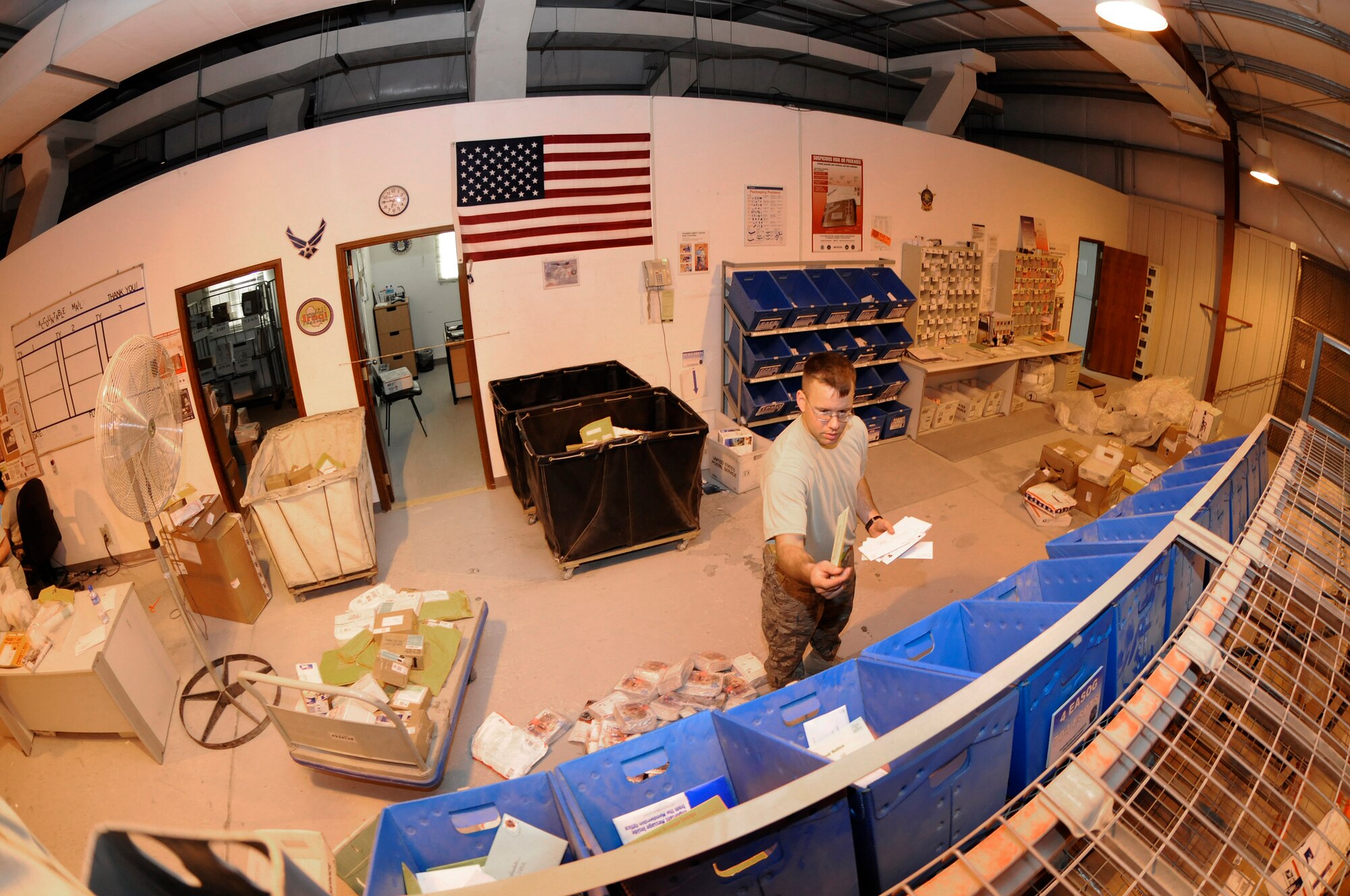 Senior Airman Jonathon Collins, 379th Expeditionary Communications Squadron, fills squadron bins with daily mail for pick up by a unit mail clerk October 2, 2008.  The mail is sorted seven mornings a week at this undisclosed air base in Southwest Asia.  Airman Collins is a native of Fergus Falls, Minn., and is deployed from Incirlik, Air Base, Turkey, in support of Operations Iraqi and Enduring Freedom and Joint Task Force-Horn of Africa.  (U.S. Air Force photo by Tech. Sgt. Michael Boquette/Released)