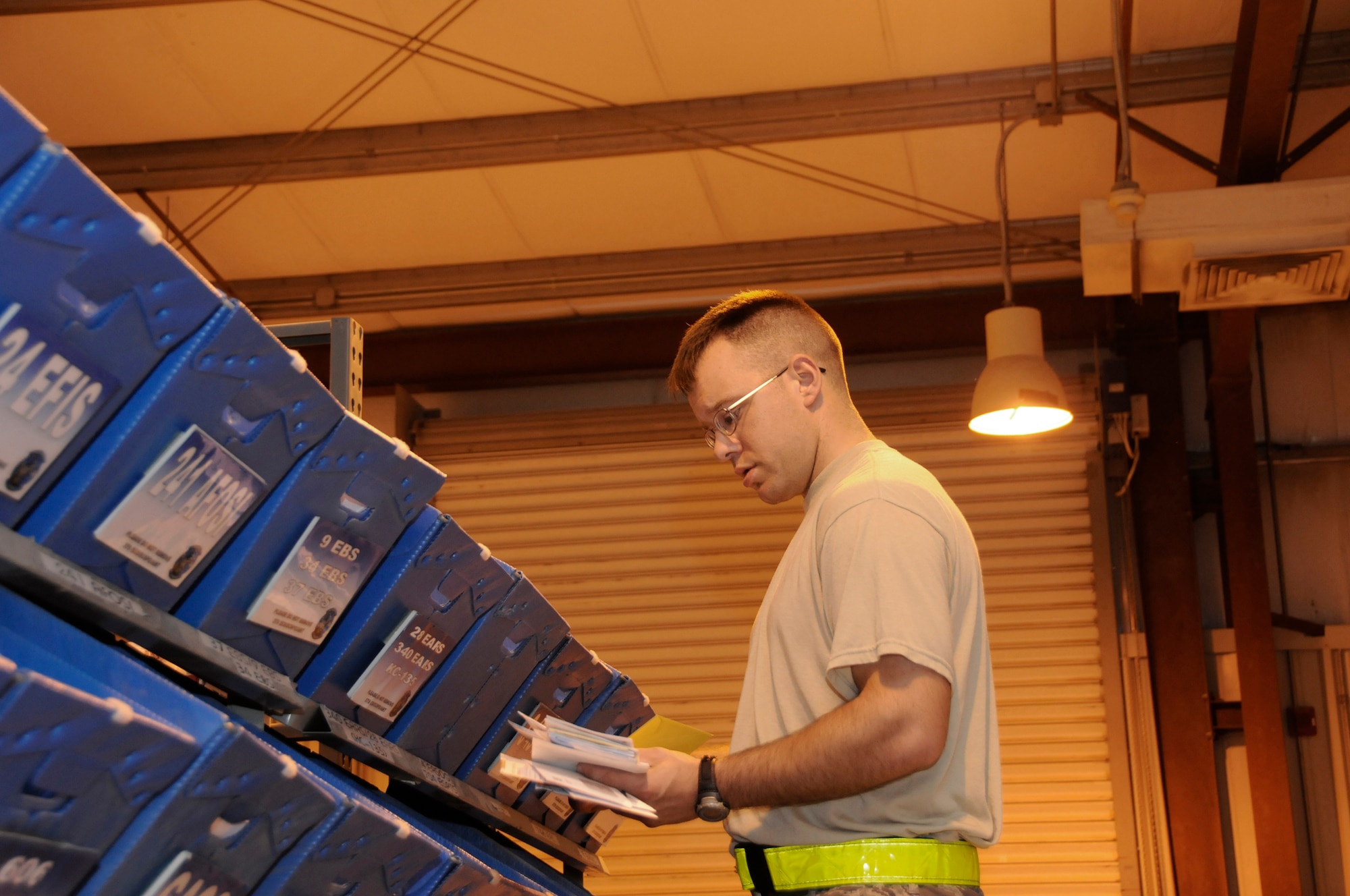 Senior Airman Jonathon Collins, 379th Expeditionary Communications Squadron, pitches personal mail into squadron bins for pick up by unit mail clerks October 2, 2008.  The mail is sorted seven mornings a week at this undisclosed air base in Southwest Asia.  Airman Collins is a native of Fergus Falls, Minn., and is deployed from Incirlik, Air Base, Turkey, in support of Operations Iraqi and Enduring Freedom and Joint Task Force-Horn of Africa.  (U.S. Air Force photo by Tech. Sgt. Michael Boquette/Released)