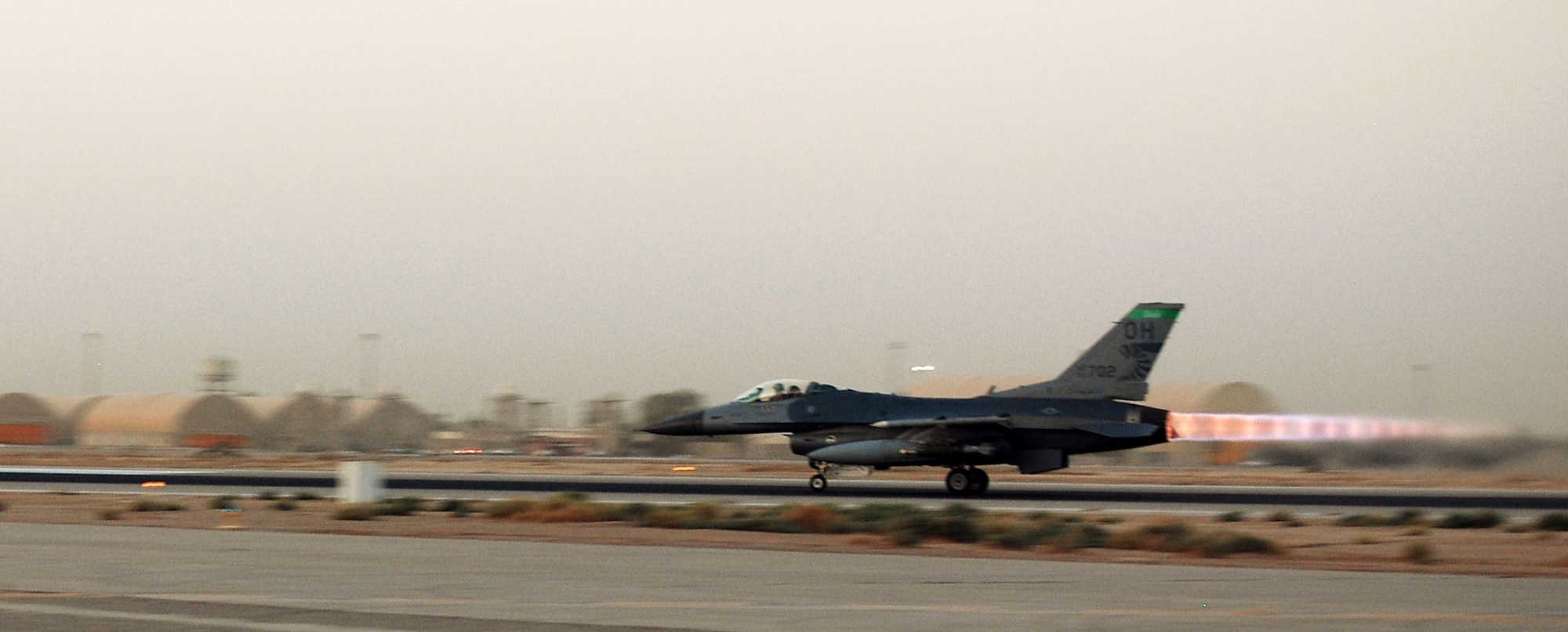 An F-16 Fighting Falcon piloted by Lt. Col. David Serage takes off on full afterburn from Joint Base Balad, Iraq, on an armed overwatch mission in support of Operation Iraqi Freedom Oct. 2. The mission was Serage's 100th combat sortie since joining the Air Force in 1989. Serage, an instructor pilot with the 332nd Expeditionary Fighter Squadron, is deployed from the Air National Guard's 138th Fighter Wing in Tulsa, Okla. (U.S. Air Force photo/Staff Sgt. Don Branum)