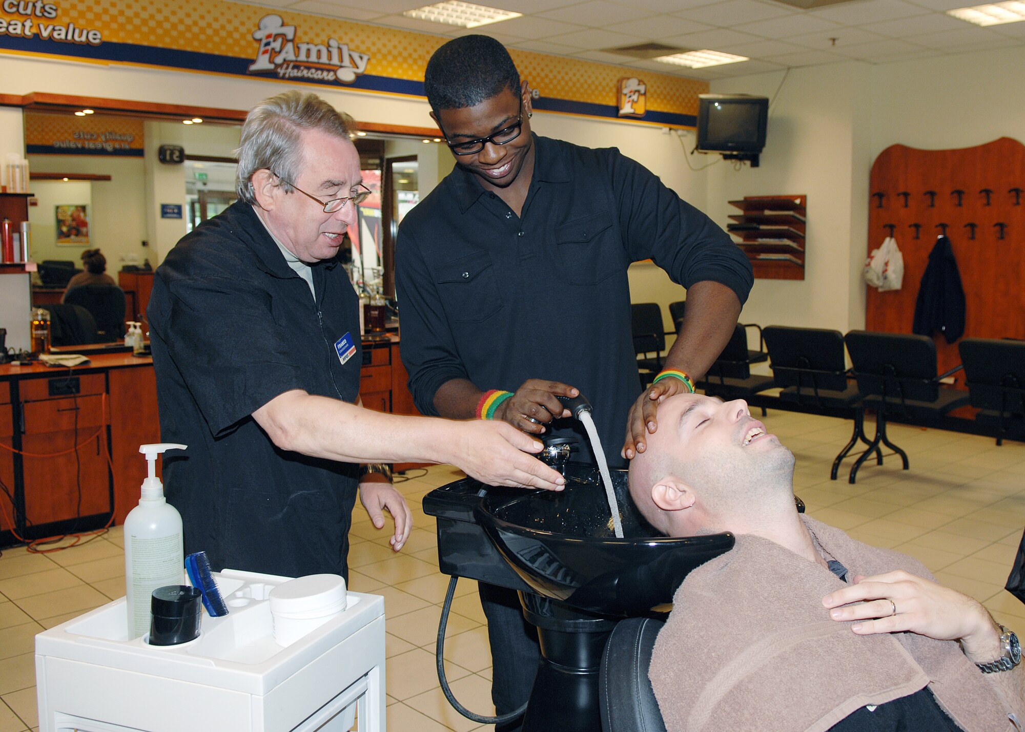Aviano barber Franco Aupiero instructs Aviano High School senior Drew James on the different aspects of the Area 1 barbershop. Drew is interning at the barbershop as part of the Aviano High School career practicum course, which affords students the opportunity to intern with base units that feature the student's career field of interest. (U.S. Air Force photo/Senior Airman Taylor Marr)