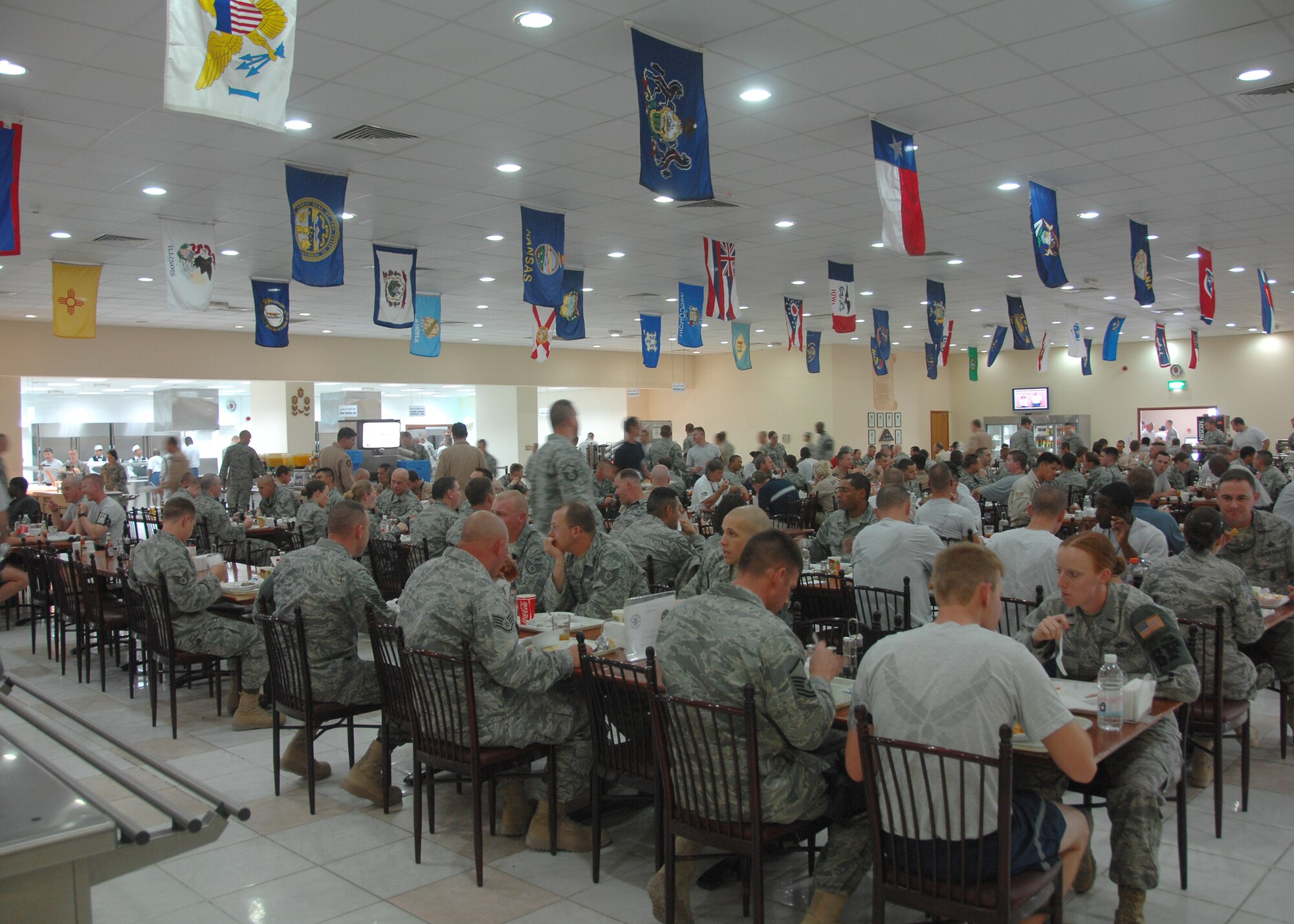 SOUTHWEST ASIA -- Airmen and Soldiers wait in line to receive a hot meal at the 386th Expeditionary Force Support Squadron Dining Facility (DFAC) on Oct. 1 at an air base in Southwest Asia. The 386th EFSS DFAC serves over 4,500 meals daily to servicemembers, making it one of the largest dining facilities in the U.S. Central Command area of responsibility. (U.S. Air Force photo/Tech. Sgt. Raheem Moore)
