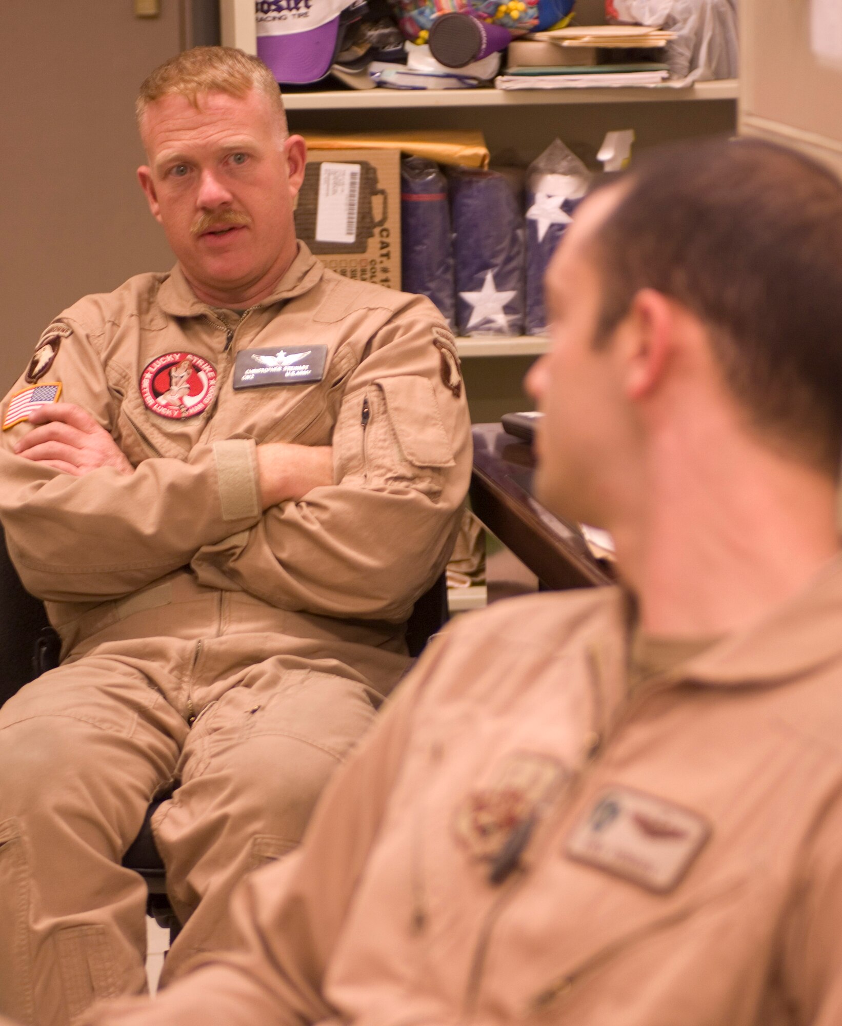 Army Chief Warrant Officer Christopher Stewart, an AH-64 Apache pilot, debriefs a joint training mission with Air Force Capt. Ryan Voneida, a HH-60 Pave Hawk pilot assigned to the 33rd Expeditionary Rescue Squadron, at Bagram Air Field, Afghanistan, Sept. 26. For the first time in Afghanistan, the Apaches and Pave Hawks are integrating operations to allow for combat search and rescue missions in high threat environments. (U.S. Air Force photo by Staff Sgt. Rachel Martinez/Released)