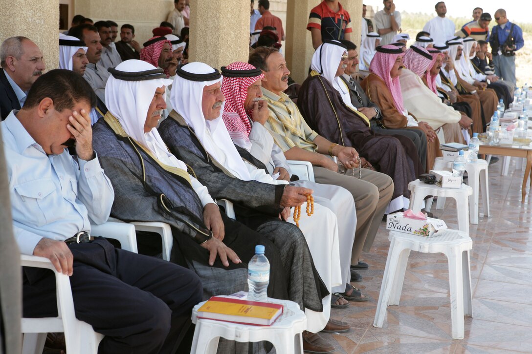 (KARMA, Iraq) Sheiks and key leaders of the Sahara tribe watch and listen as various figures speak of progress in the greater Karmah region and the continual transition of security from Coalition forces, Oct. 4. Approximately 50 of the most prominent sheiks and local leaders attended the public forum. (Photo by Lance Cpl. Achilles Tsantarliotis)