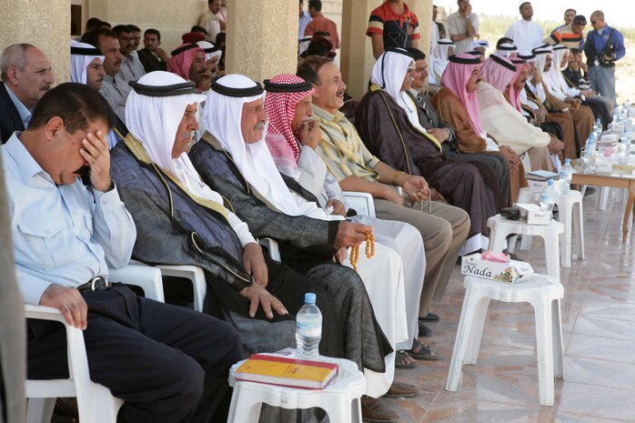 (KARMA, Iraq) Sheiks and key leaders of the Sahara tribe watch and listen as various figures speak of progress in the greater Karmah region and the continual transition of security from Coalition forces, Oct. 4. Approximately 50 of the most prominent sheiks and local leaders attended the public forum. (Photo by Lance Cpl. Achilles Tsantarliotis)