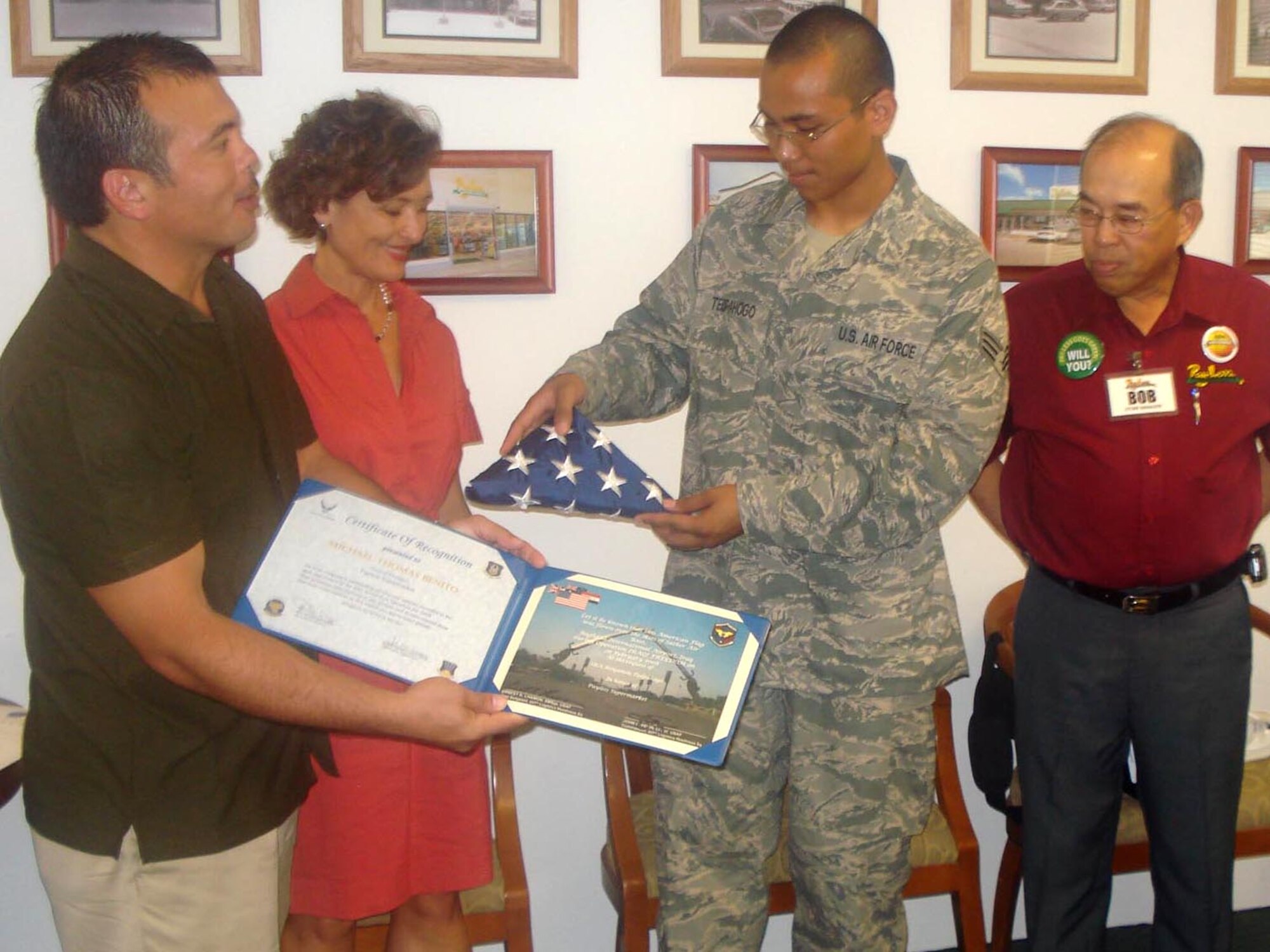 In appreciation for employer support during his recent deployement, Senior Airman Benjamin Tedpahogo, 44th Aerial Port Squadron, Andersen Air Force Base, Guam, presents an American flag flown over Iraq with certificate to Michael Benito and Kathy Sgro, Payless Supermarkets general managers, July 3, 2008. While deployed to Sather Air Base, Iraq, Airman Tedpahago received received care packages from his fellow employees at Payless Supermarkets which he shared with the rest of the 44th APS team members stationed with him in the desert. The 44th APS is part of the 624th Regional Support Group, headquartered at Hickam Air Force Base, Hawaii.