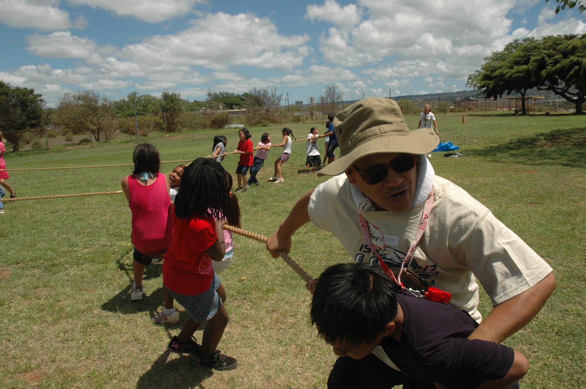 Master Sgt. Robert Tancayo, 624th Civil Engineer Squadron, tries to give his team the edge in a four-way tug-of-war match at Makalapa Elementary School's Field Day, May 28-29. 624th CES is a part of the 624th Regional Support Group, Hickam Air Force Base, Hawaii. The 624th RSG has been involved with Makalapa since 2004 as part of the Hickam School Partnership program. (U.S. Air Force photo/Master Sgt. Daniel Nathaniel)