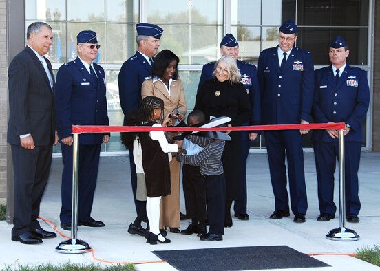 WRIGHT-PATTERSON AFB, Ohio – Ms. Melodie Homer cuts the ceremonial ribbon during the Operations Building dedication Oct. 4, 2008, at the 445th Airlift Wing.  The building was dedicated in honor of her late husband, Maj. LeRoy W. Homer, Jr., who served with the wing from 1995 to 2000 and died Sept. 11, 2001.  Overlooking the ribbon cutting are Col. (ret.) Robert Shondel; Col. Roger Gallet, 445th Operations Group commander, Maj. Gen. Robert E. Duignan, Fourth Air Force commander; Maj. Homer’s mother, Ms. Ilse Homer; Lt. Gen. Charles E. Stenner, Air Force Reserve Command commander; Col. Stephen Goeman, 445th Airlift Wing commander; Lt. Col. Chris Clark, 445th Operation Group deputy commander; Maj. and Ms. Homer’s children, Laurel and Alden; and one other relative.  (Air Force photo/Ben Strasser)