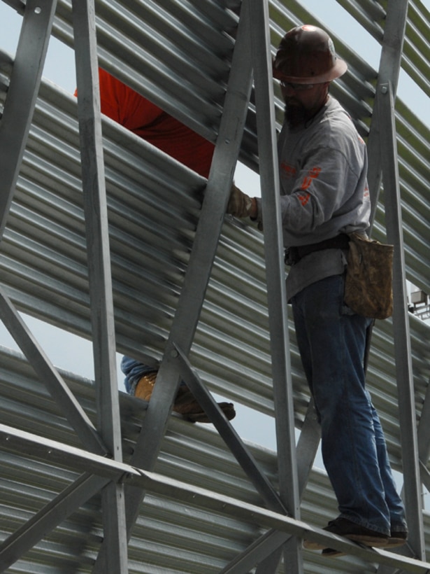A blast deflector takes the exhaust coming out of the back end of a fighter plane, commonly known as jet blast, and deflects it harmlessly up into the air in order to protect things such as buildings, people, and equipment.