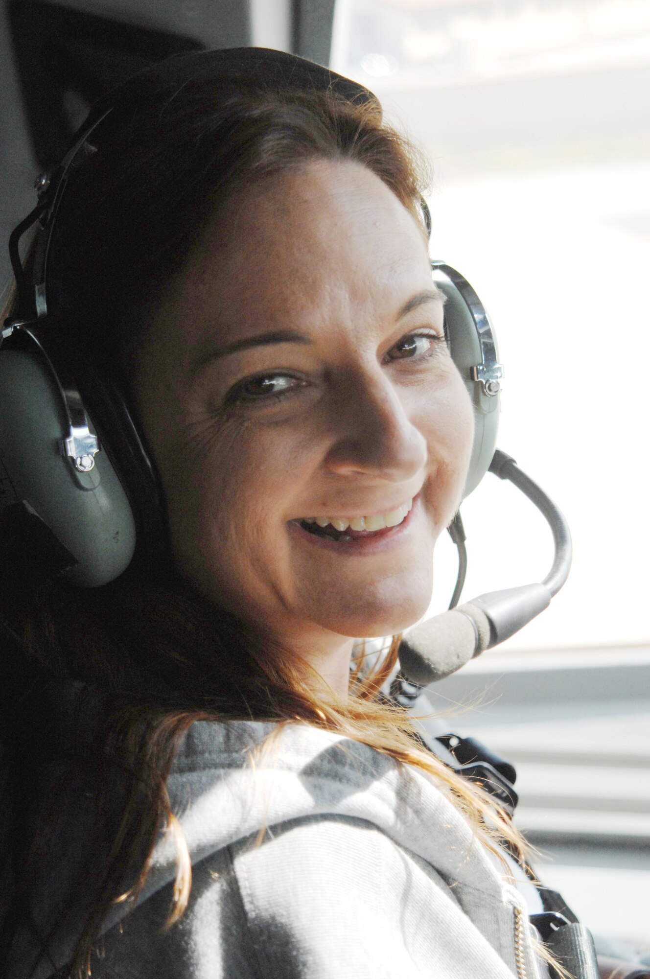 Joanne Lazano, from Mesa, Ariz., sits behind the pilot during departure on a C-17 aircraft. (U.S. Air Force photo by Senior Master Sgt. Kim Allain)