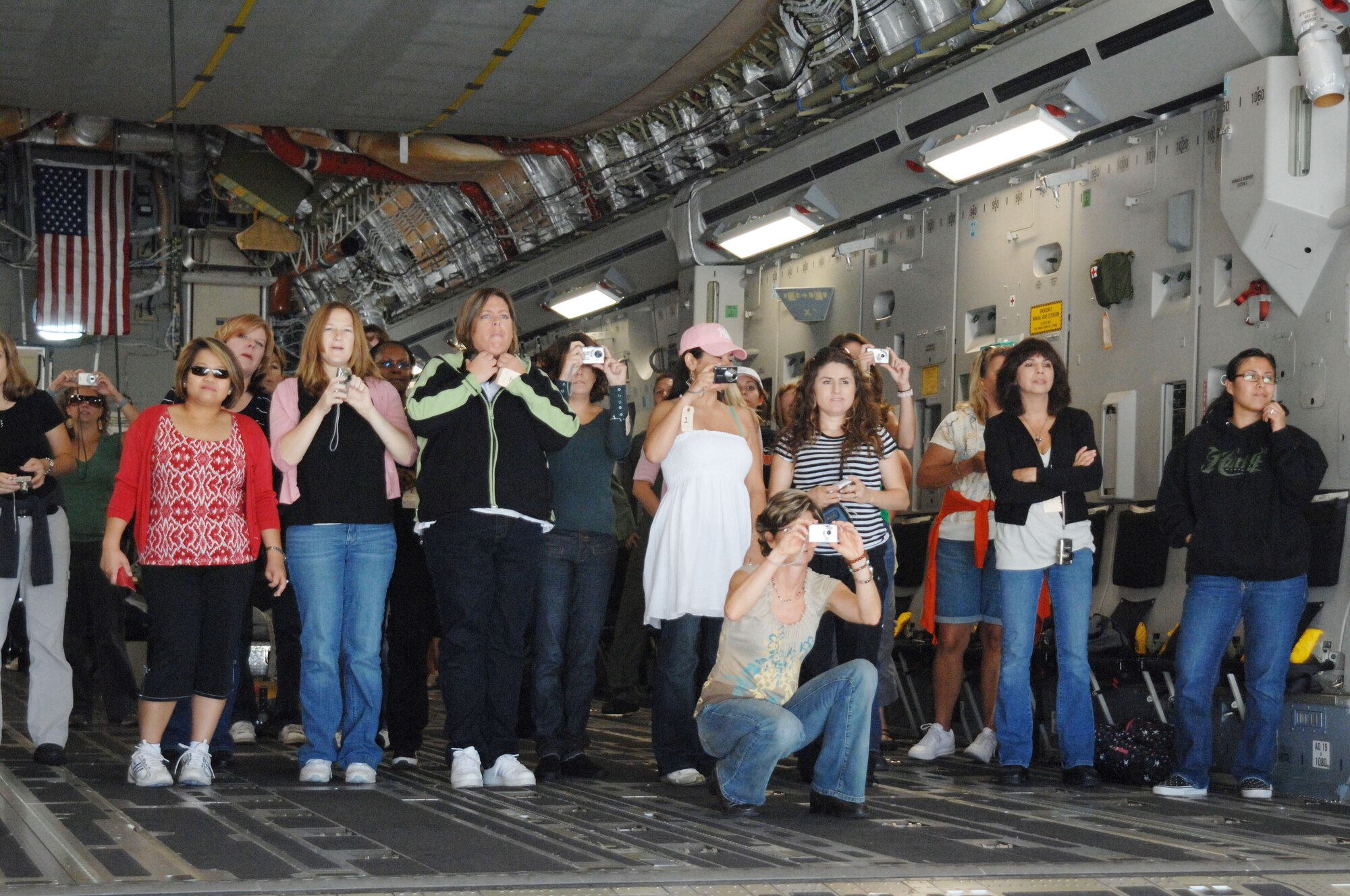 Military spouses take photographs of the flight line welcome home ceremony for Marines returning from Iraq from the ramp of a C-17 Globemaster III aircraft at March ARB. (U.S. Air Force photo by Senior Master Sgt. Kim Allain)