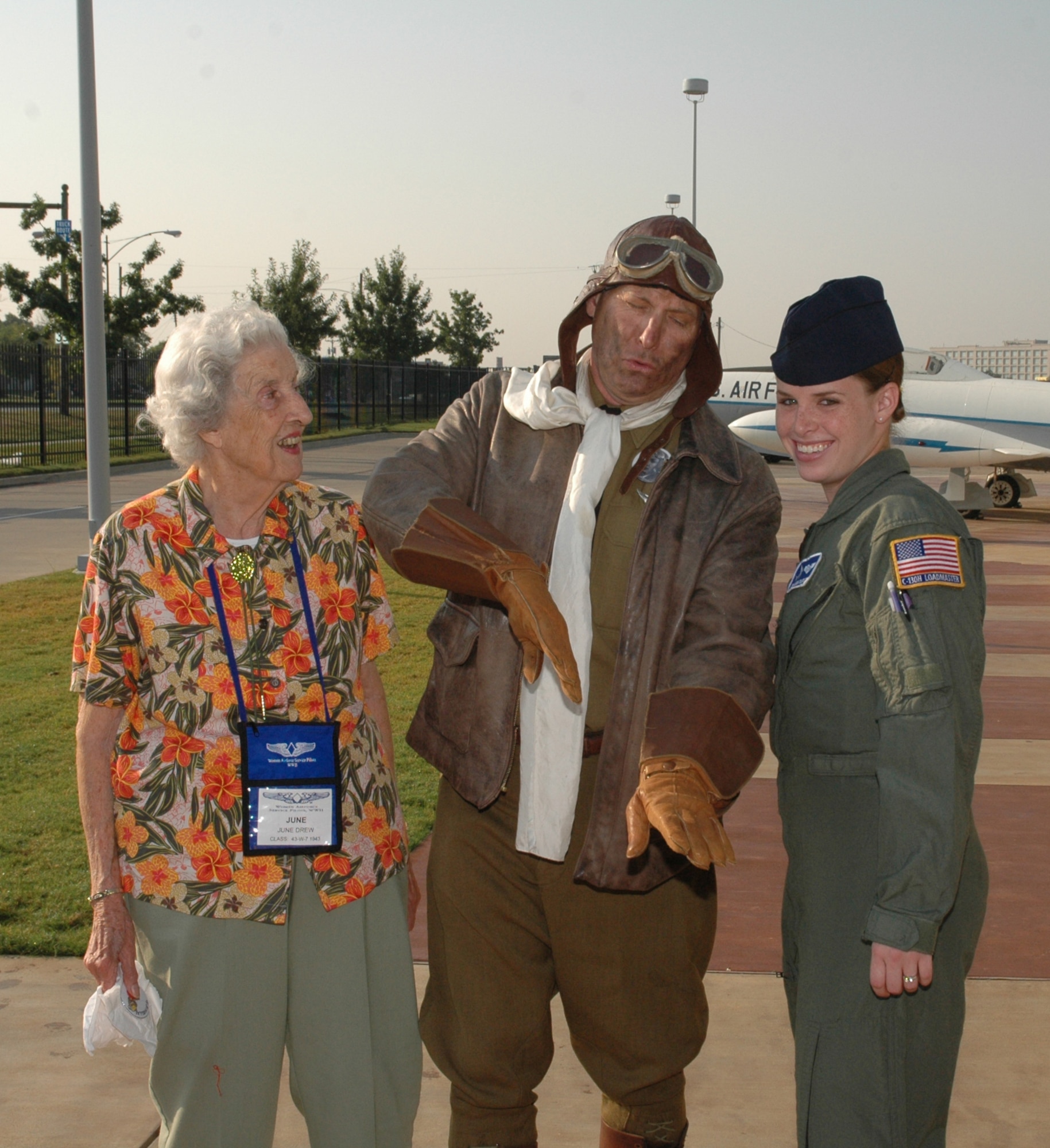 Dressed as a World War II flyer, Michael Vincent of Flagstaff, Ariz., poses with former WASP June Drew and Senior Airman Leigha Samples. Vincent is a WASP historian and archivist. Samples is a C-130 Hercules loadmaster with Maxwell AFB, Ala.'s 357th Airlift Squadron, 908th Airlift Wing. (U.S. Air Force Photo by Staff Sgt. Jay Ponder