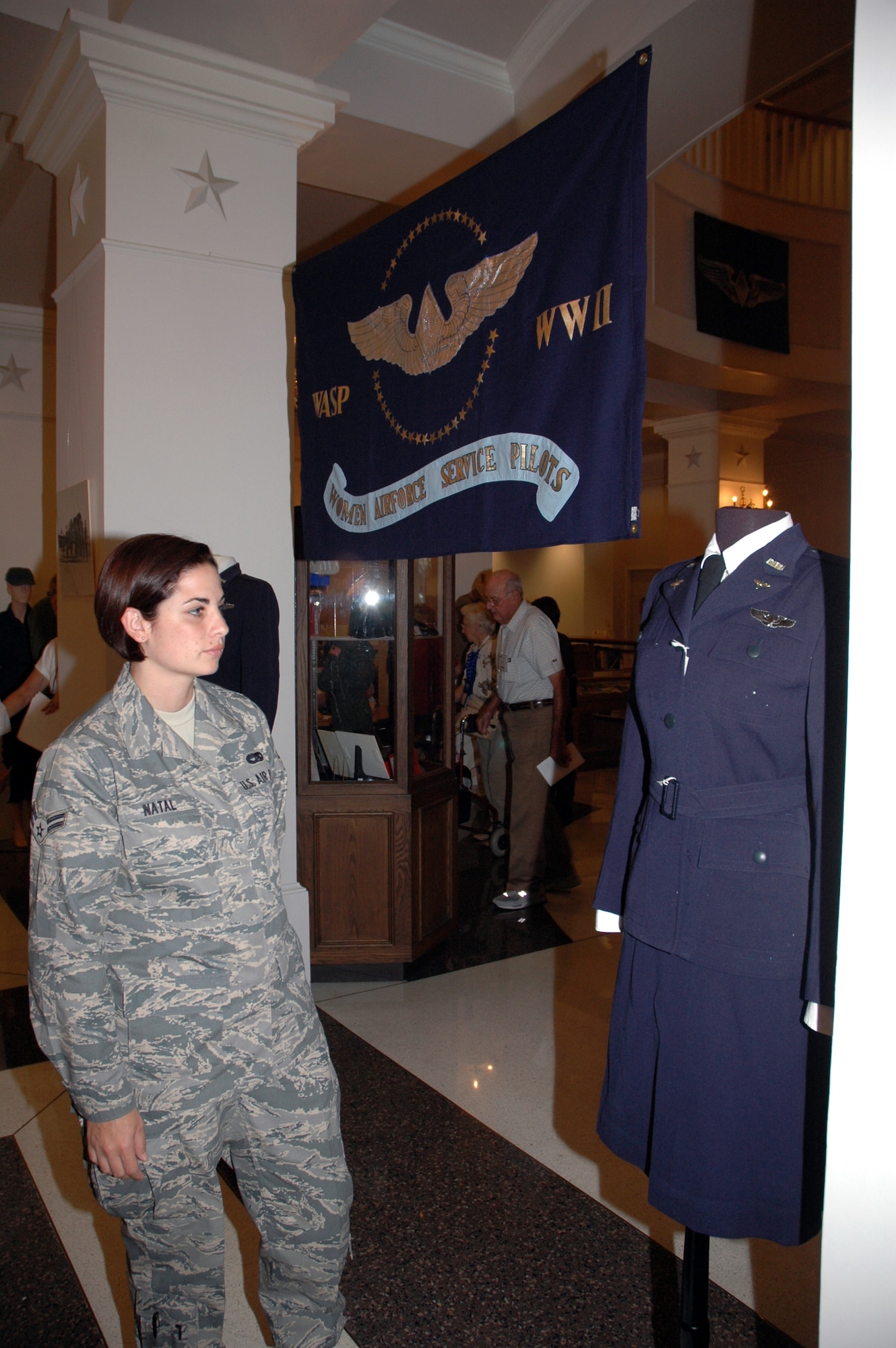 Air Force Reservist Airman 1st Class Veronica Natal, an air transporatation specialist with the 25th Aerial Port Squadron, Maxwell AFB, Ala.'s 908th Airlift Wing, admires a WASP uniform on display at the new WASP archive museum at The Texas Women's University library. (U.S. Air Force Photo by Staff Sgt. Jay Ponder