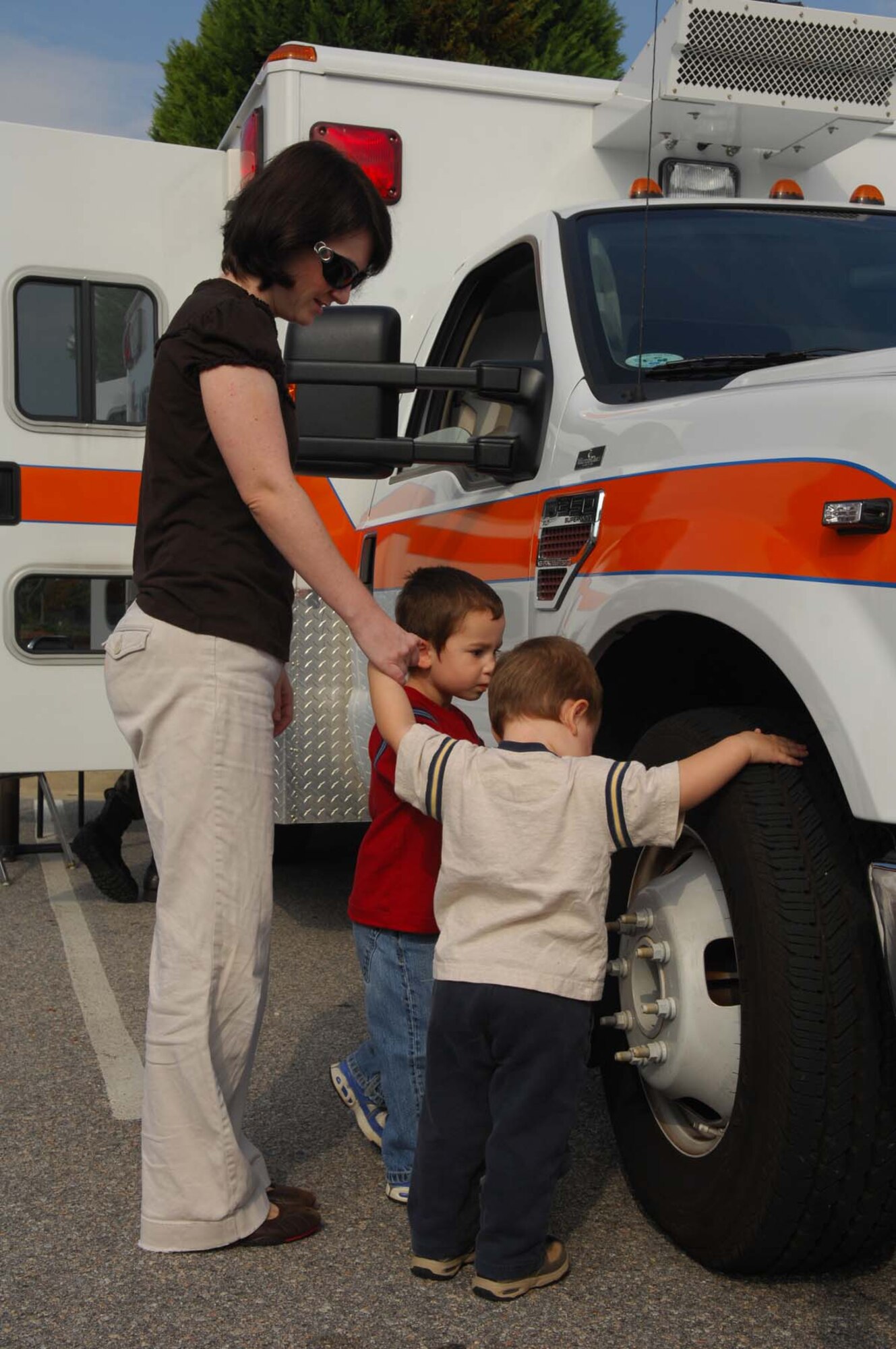 SHAW AIR FORCE BASE, S.C. -- Laura Cantore watches sons David and Daniel check out one of the ambulances used by the 20th Medical Group during the Shaw Community Awareness Day Oct. 4. The Shaw Community Awareness Day shows Airmen and families the 20th Fighter Wing personnel who provide support for the base. (U.S. Air Force photo/ Senior Airman Matthew Davis)  