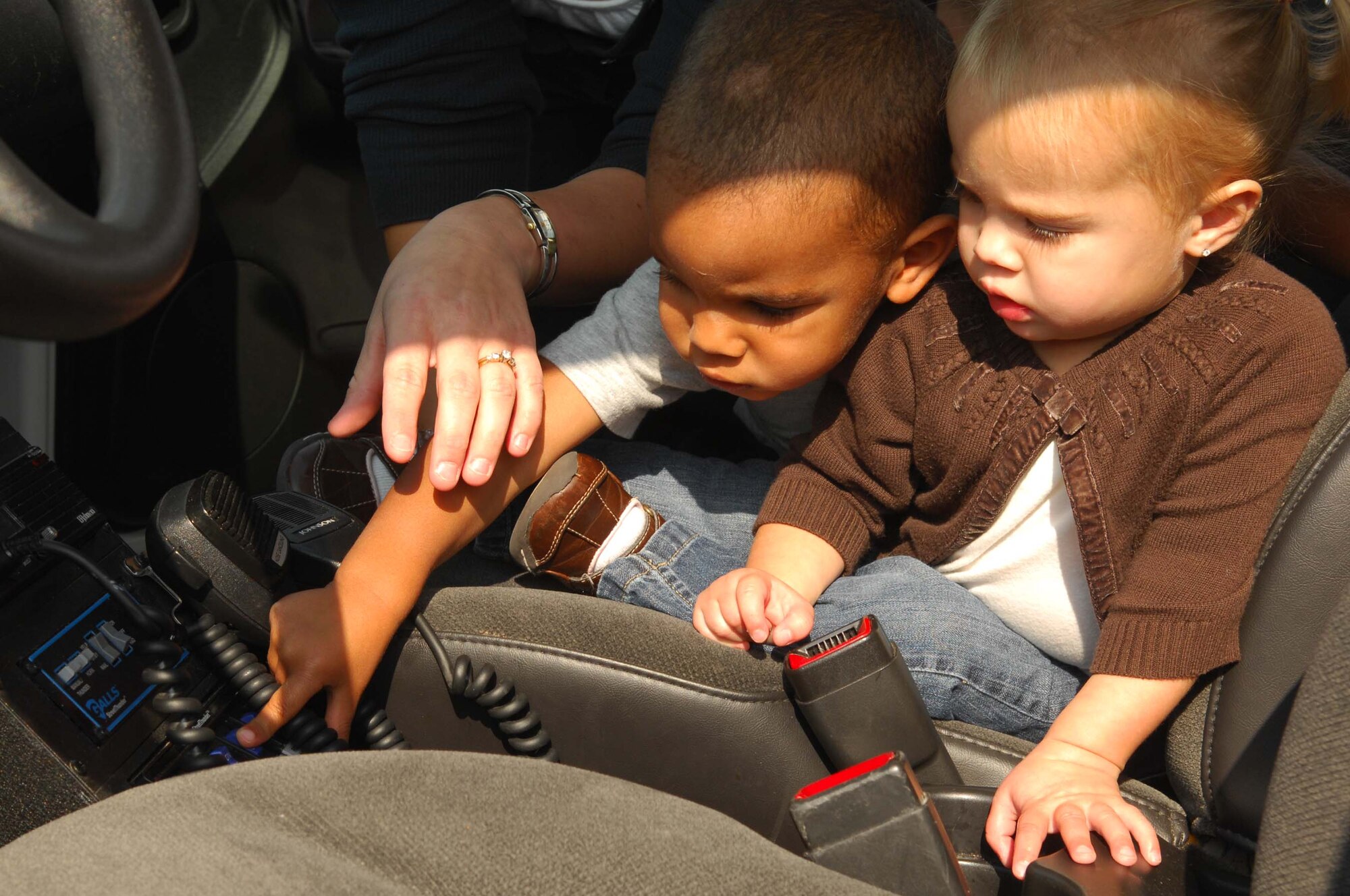 SHAW AIR FORCE BASE, S.C. -- Kamrynn Devall and Kameron Fontenot play with electronics in a 20th Security Forces Squadron patrol car on display during the Shaw Community Awareness Day Oct. 4. The Shaw Community Awareness Day shows Airmen and families the 20th Fighter Wing personnel who provide support for the base. (U.S. Air Force photo/ Senior Airman Matthew Davis)  