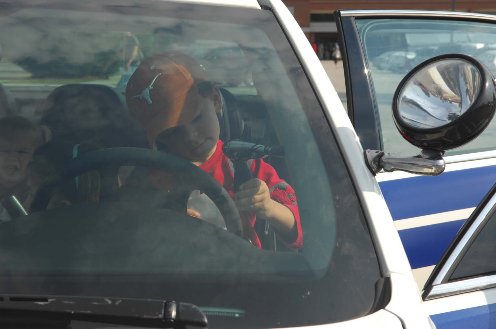 SHAW AIR FORCE BASE, S.C. -- Brady Renner checks out a spot light in a 20th Security Forces Squadron patrol car on display during the Shaw Community Awareness Day Oct. 4. The Shaw Community Awareness Day shows Airmen and families the 20th Fighter Wing personnel who provide support for the base. (U.S. Air Force photo/ Senior Airman Matthew Davis)  