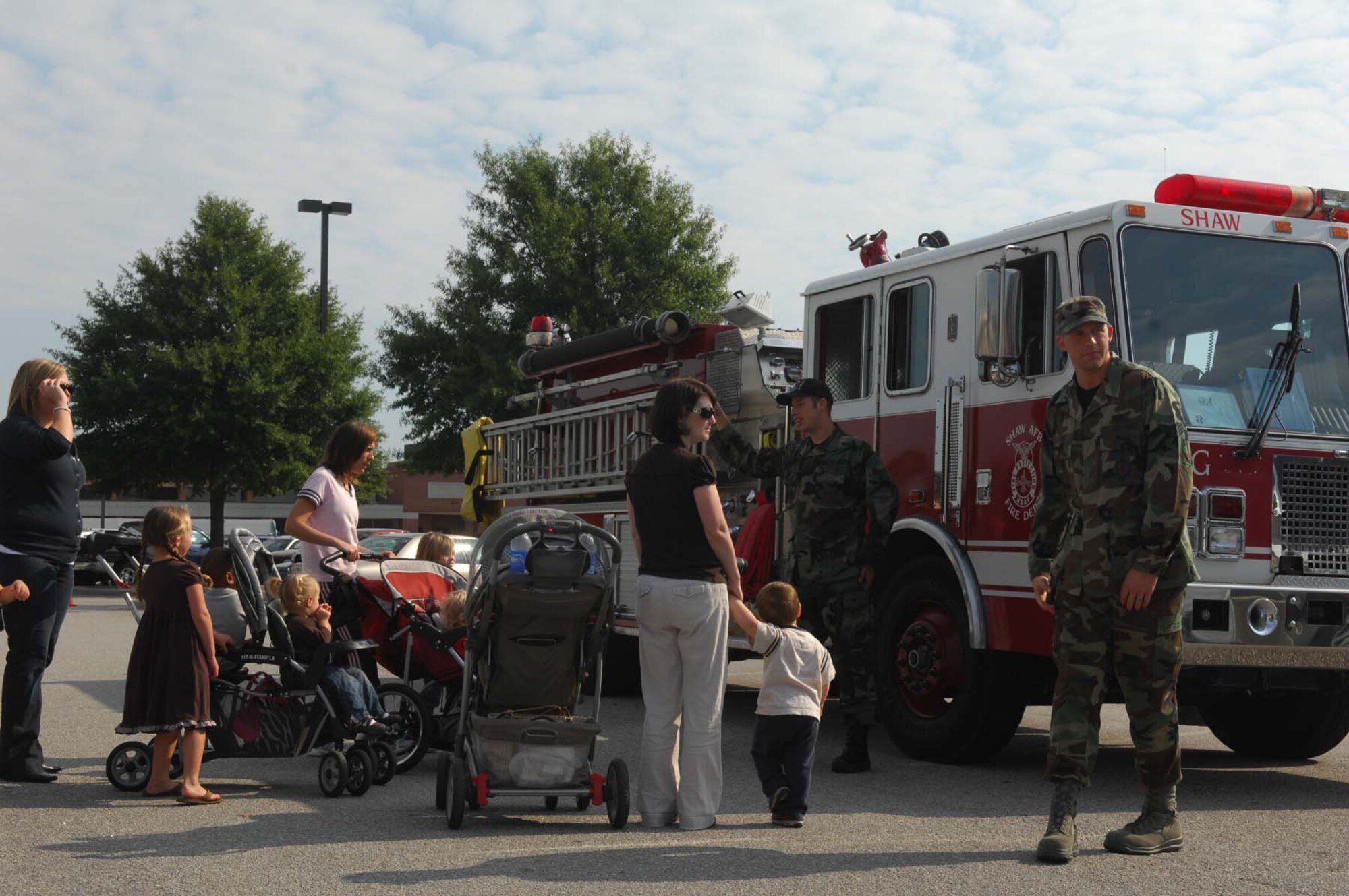 SHAW AIR FORCE BASE, S.C. -- Airmen and families check out a firetruck from the 20th Civil Engineering Squadron during the Shaw Community Awareness Day Oct. 4. The Shaw Community Awareness Day shows Airmen and families the 20th Fighter Wing personnel who provide support for the base. (U.S. Air Force photo/ Senior Airman Matthew Davis)  