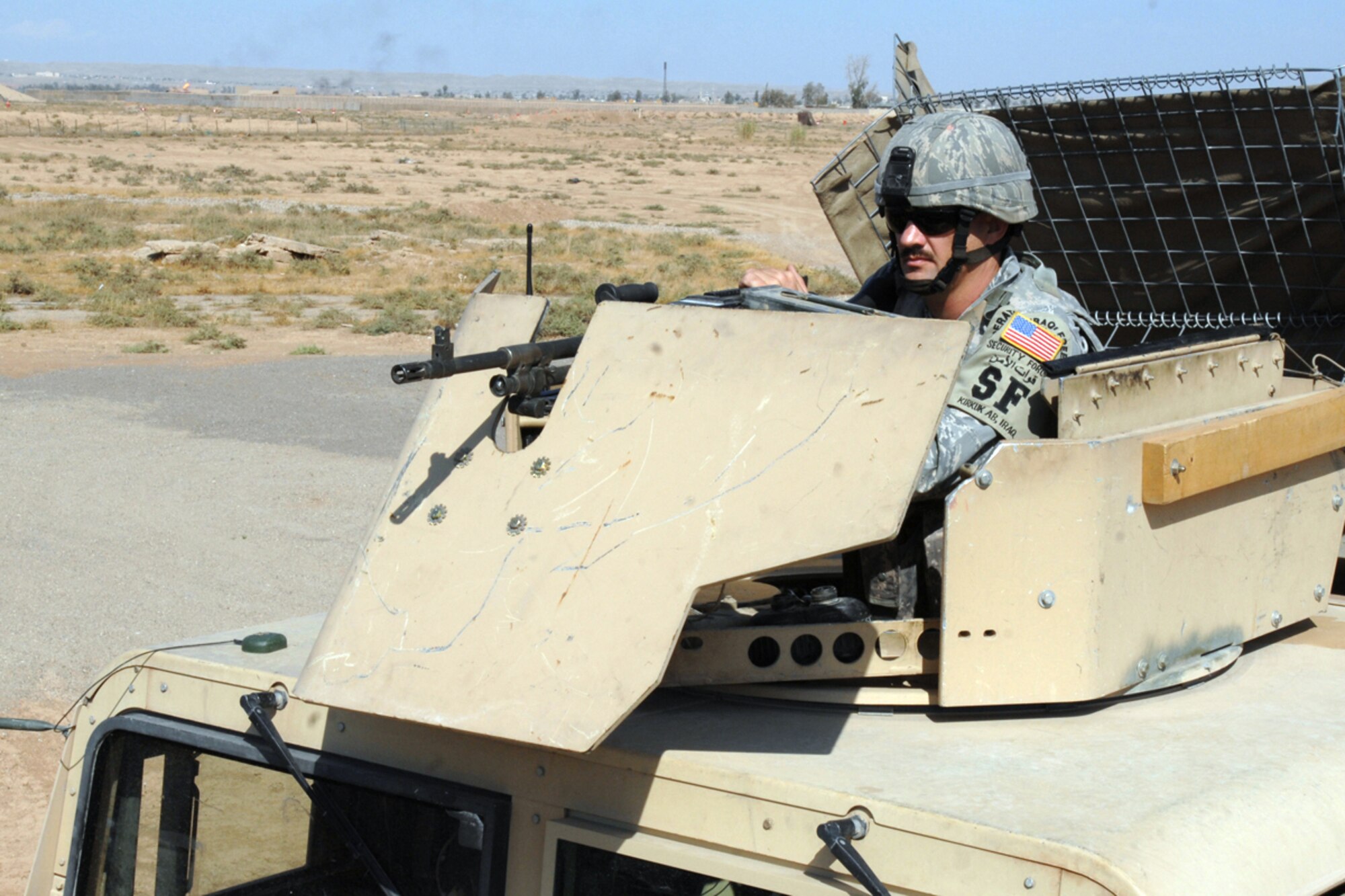 Tech. Sgt. Edward Akin, a mobile patrol fire team leader with the 506 Expeditionary Security Forces Squadron scans the fence line of bravo sector here, Oct 1, 2008. Sergeant Akin and his team are trained to provide an armed response capable to limit, counteract and neutralize hostile actions directed against the installation or its vital resources. Sergeant Akin is deployed from Barksdale Air Force Base, La., and calls Carthage, Texas home. (Air Force Photo/Tech. Sgt. Jeff Walston)  