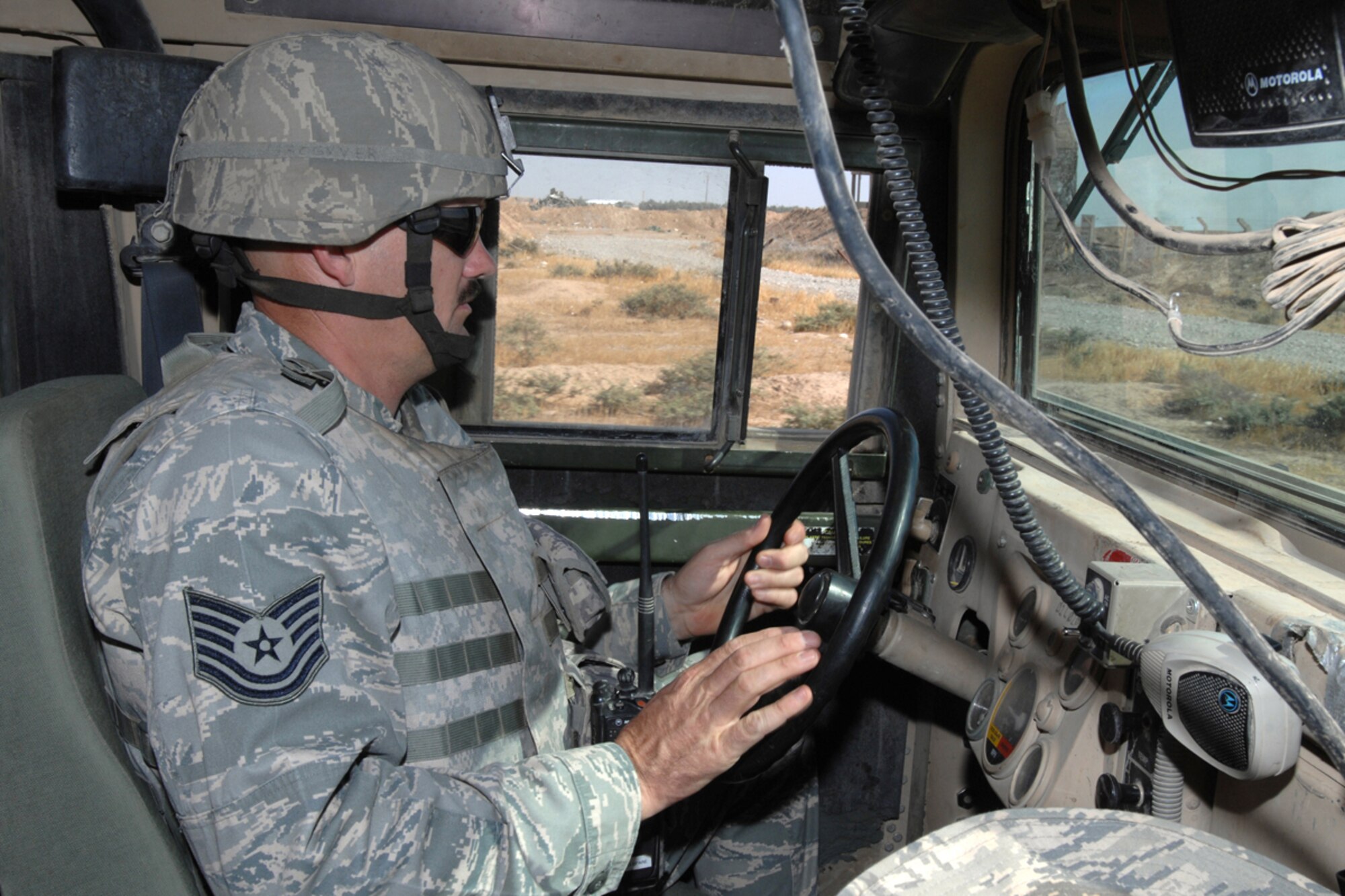 Tech. Sgt. Edward Akin, a mobile patrol fire team leader with the 506 Expeditionary Security Forces Squadron patrols bravo sector of the perimeter road here, Oct 1, 2008. Sergeant Akin and his team are trained to provide an armed response capable to limit, counteract and neutralize hostile actions directed against the installation or its vital resources. Sergeant Akin is deployed from Barksdale Air Force Base, La., and calls Carthage, Texas home. (Air Force Photo/Tech. Sgt. Jeff Walston)  