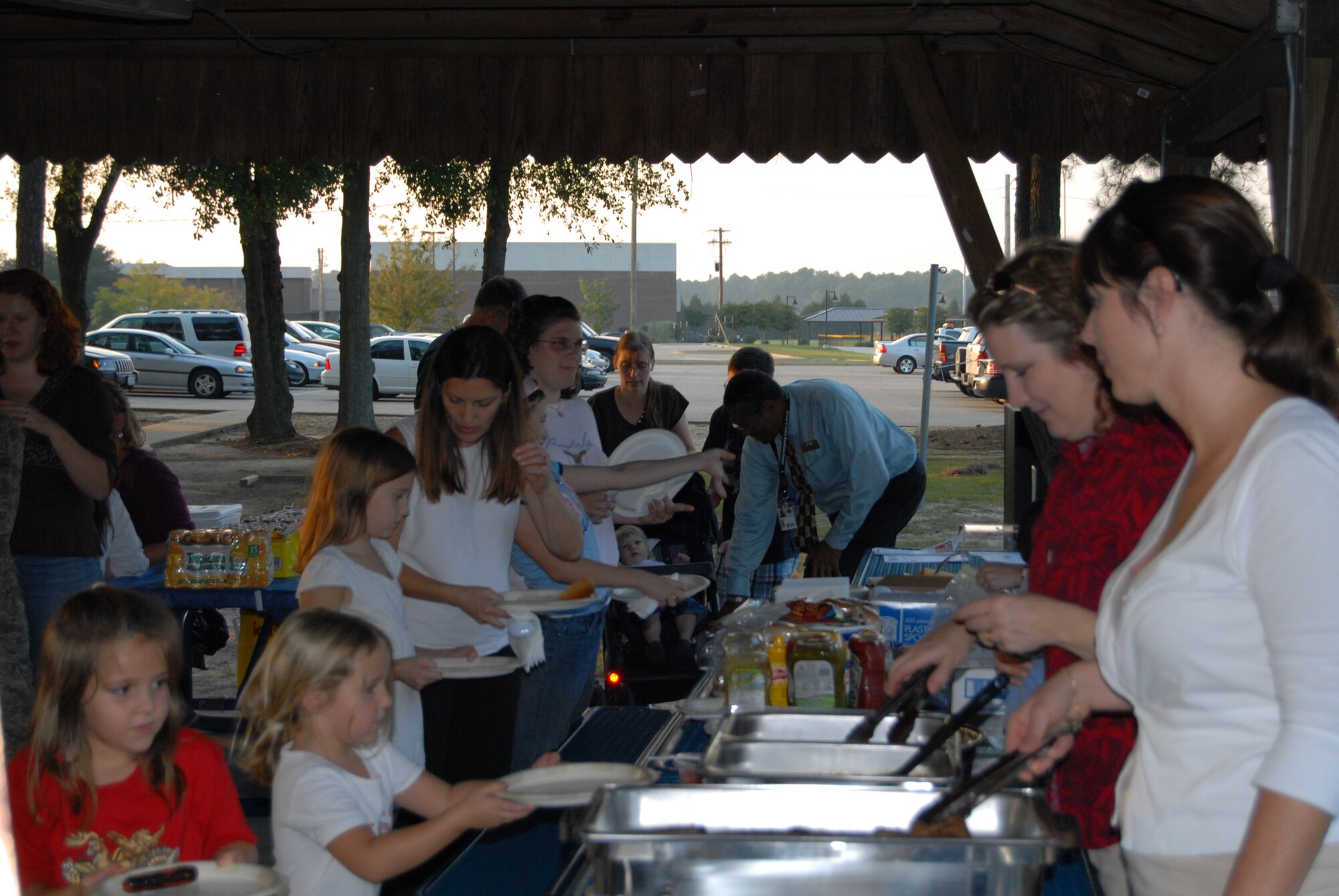Spouses of deployed members enjoy a free picnic Tuesday at Woodland Park. The Phoenix Spouses of Pope served the food to the families as the Airman and Family Readiness Center prepared the food and the events for the evening. Some of the events included an obstacle course and dodgeball game for the children and a free drawing for the spouses. Given away were two family four-pack passes to see the “Walking with Dinosaurs” live show in Raleigh, passes to a “Disney on Ice” show and a $50 gas card. (U.S. Air Force Photo by Tech. Sgt. Todd Wivell)