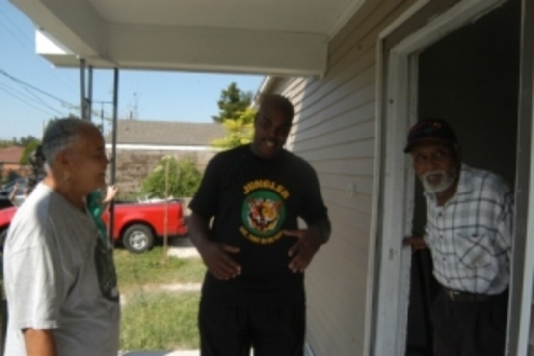 Sgt. Kenneth Avery, a MFR Toys for Tots coordinator, takes a break to chat with Manson McDonald and Jackie Haynes, who reside in the home that Marines and civilian volunteers helped paint during the first and second weekends of October. This is an ongoing effort by MFR to help restore New Orleans and its surrounding communities.