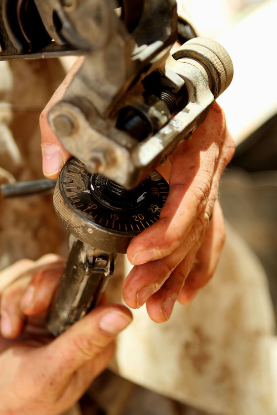 Cpl. Dennis D. Merritt, a small-arms technician with Headquarters and Service Company, 1st Light Armored Reconnaissance Battalion, Regimental Combat Team 5, adjusts a traversing and elevation mechanism for a M240E1 machinegun at Camp Korean Village, Iraq, Oct. 4. Armorers are responsible for repairing, maintaining and improving everything from pistols to rifles to grenade launchers with meticulous care.::r::::n::