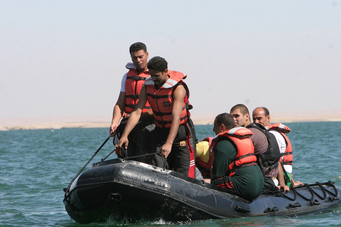A group of Iraqi policemen prepare to practice some of the boating maneuvers they learned from Riverine Squadron 3, Riverine Detachment 2, 3rd Battalion, 7th Marine Regiment, Regimental Combat Team 5, at Lake Qadisiyyah, Iraq, Oct. 4. The police came from several different police departments in western al-Anbar province to be trained in boat safety and basic seamanship. This is the fourth class the Riverines have held to train Iraqi policemen, and the graduates will be able to return to their respective police departments and share the knowledge they learned with their fellow policemen.::r::::n::