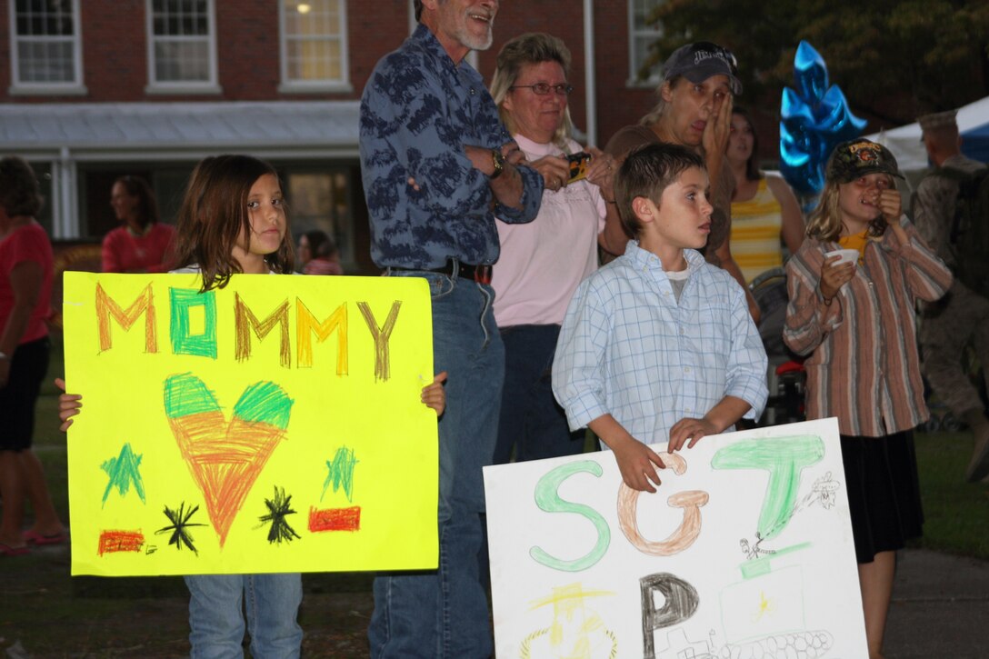 Family members eagerly await the first load of Marines bus to arrive from MCAS Cherry Point.