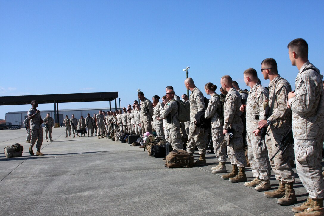 24th Marine Expeditionary Unit Marines receive final instructions about customs and luggage retrieval before boarding transportation to Camp Lejeune.