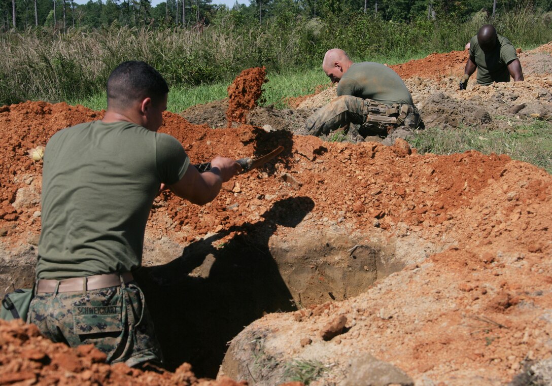 Marines from Kilo Company, Battalion Landing Team, 3rd Battalion, 2nd Marine Regiment, 22nd Marine Expeditionary Unit, dig fighting positions in preparation for live-fire squad training Oct. 3, 2008, aboard Fort Pickett, Va., a Virginia Army National Guard Maneuver Training Center. The squad training was part of the unit's off-site training, the first major training evolution for the 22nd MEU's pre-deployment training cycle.  BLT 3/2 is the Ground Combat Element of the 22nd MEU, which is scheduled for a six-month deployment next spring. (Official Marine Corps Photo by Cpl. Theodore W. Ritchie)::r::::n::