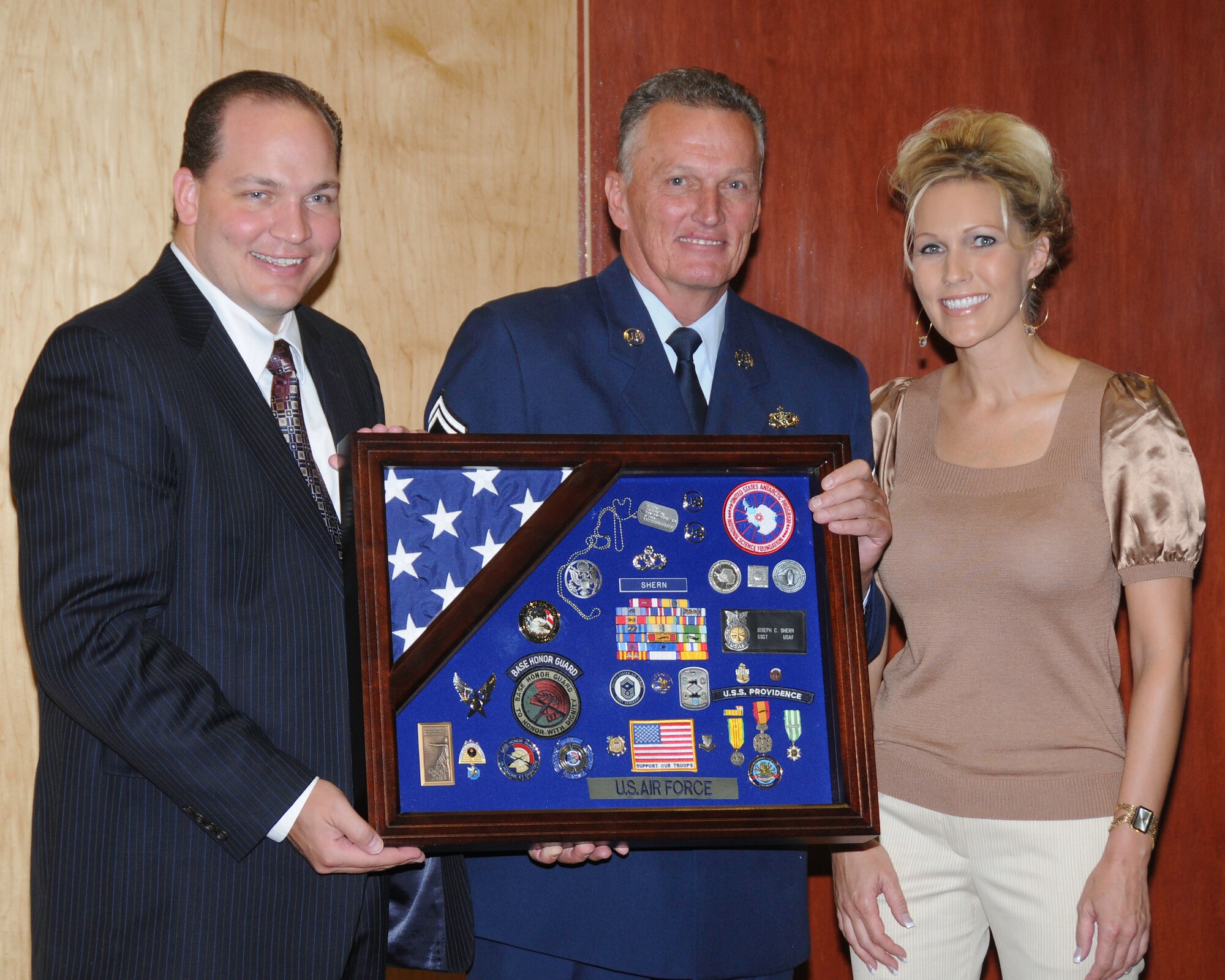 Senior Master Sergeant Joseph Shern receives a shadow box presented by his children Wendy and Cecal during his retirement ceremony.  Utah Air National Guard Base, Salt Lake City, Utah. October 5, 2008
Photo by: TSgt Michael  D Evans  

