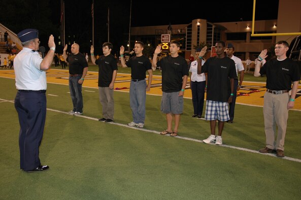 HATTIESBURG, Miss.--Recruits who will join the Air Force Reserve team swear the Oath of Enlistment delivered by Brig. Gen. Richard Moss, commander of the 403rd Wing at Keesler Air Force Base, during halftime at a football game between the University of Southern Mississippi and the University of Texas-El Paso Oct. 4. The mass enlistment involved recruiting units from the Mississippi Gulf Coast, Hattiesburg, and Mobile, Ala. regions. (U.S. Air Force Photo/Tech. Sgt. Michael Duhe)