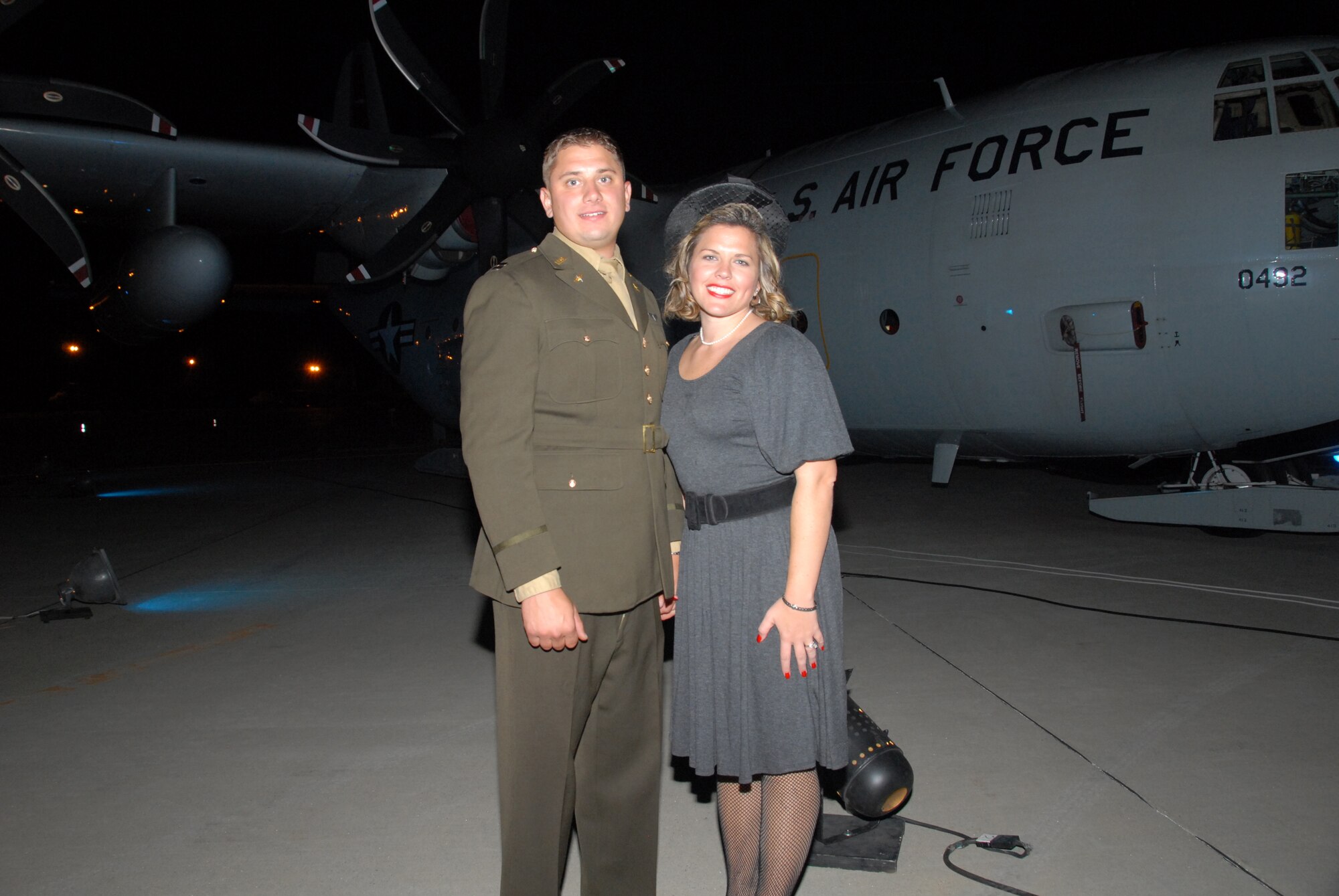 Capt. Matt Sala and his wife, Carie, stand in front of an LC-130 during the base's 60th Anniversary Hangar Dance on Oct. 4. Vintage World War II aircraft were also on display right outside the hangar. (U.S. Air Force photo by Master Sgt. Willie Gizara)