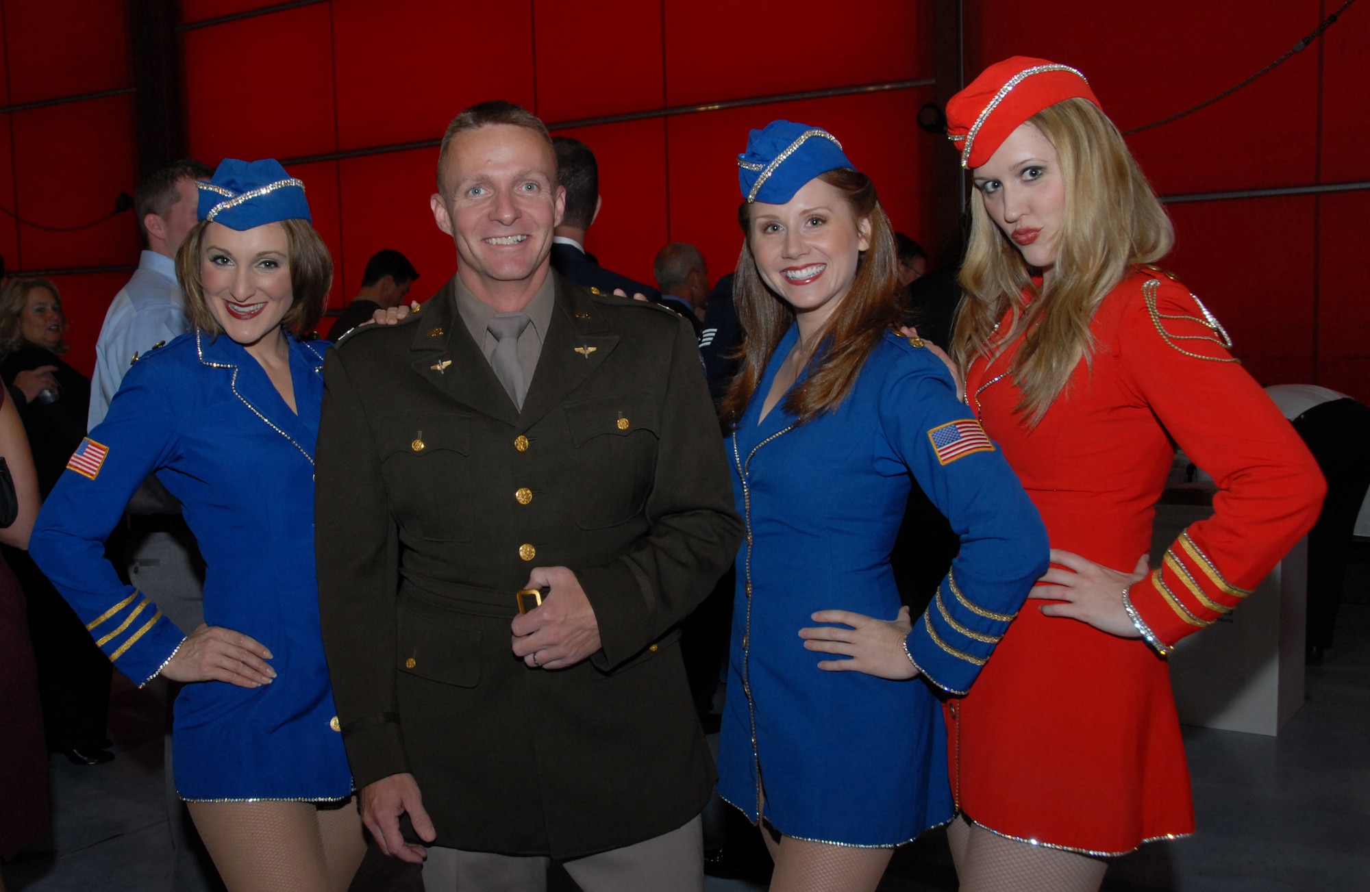 Capt. Ernest Lancto, dressed in an Army Air Corps uniform, poses with the Liberty Belles at the 109th Airlift Wing's 60th Anniversary Hangar Dance on Oct. 4. The Liberty Belles are a USO-style group and performed at the event. (U.S. Air Force photo by Master Sgt. Willie Gizara)