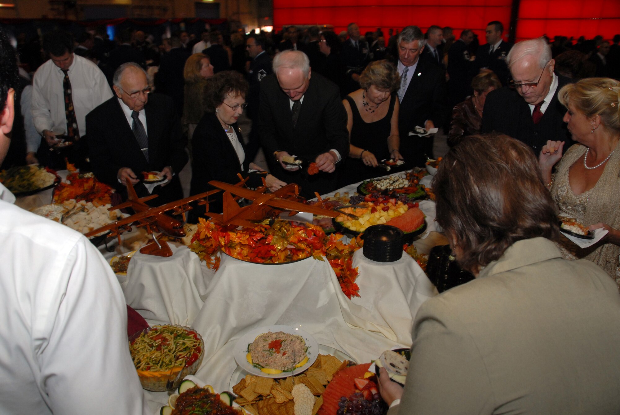 Guests grab some food during the 109th Airlift Wing's 60th anniversary celebration Oct. 4. About 800 people gathered in Hangar 8 for the event. (U.S. Air Force photo by Master Sgt. Willie Gizara)