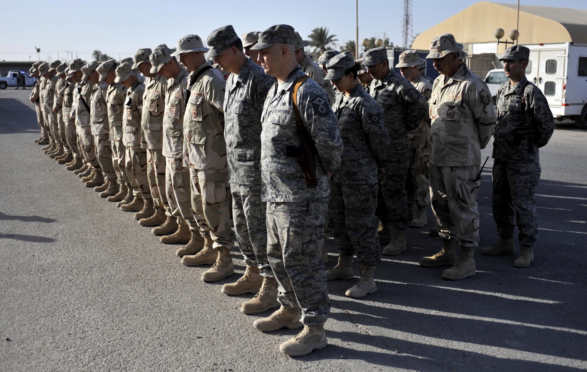 10/05/2008 ? SATHER AIR BASE, Iraq ? Deployed firefighters and emergency medical personnel bow their heads for a moment of reflection and prayer in observance of the National Fallen Firefighters Memorial Service, which is held annually in Emmitsburg, Md.(U.S. Air Force photo by Master Sgt. Brian Davidson)