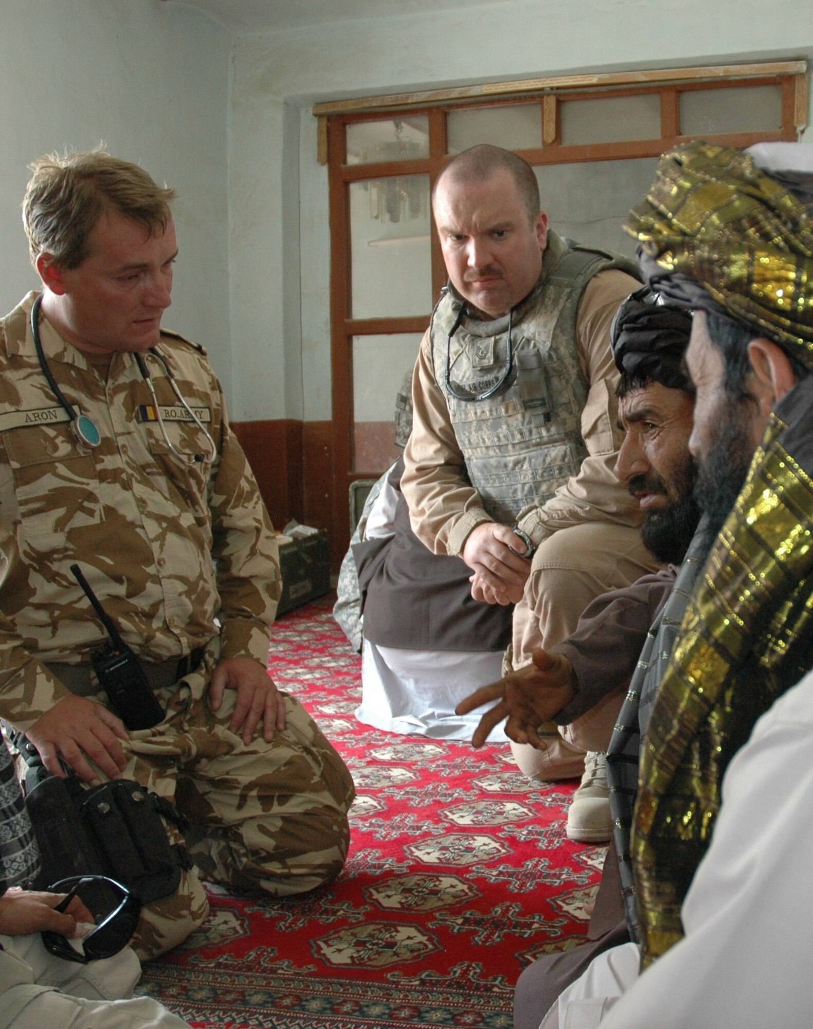 Romanian Maj. Daniel Aron (left) and U.S. Air Force Tech. Sgt. Michael Denton provide medical assistance to villagers in Jarullah, Zabul Province, Afghanistan, Oct. 2. Aron is a doctor with the Romanian Army’s 30th Mountain Battalion and Denton is with the Zabul Provincial Reconstruction Team medical staff. Zabul PRT doctors and medics mentored their Romanian counterparts during the battalion’s first village medical outreach. (U.S. Air Force photo by Capt. Jean Duggan)