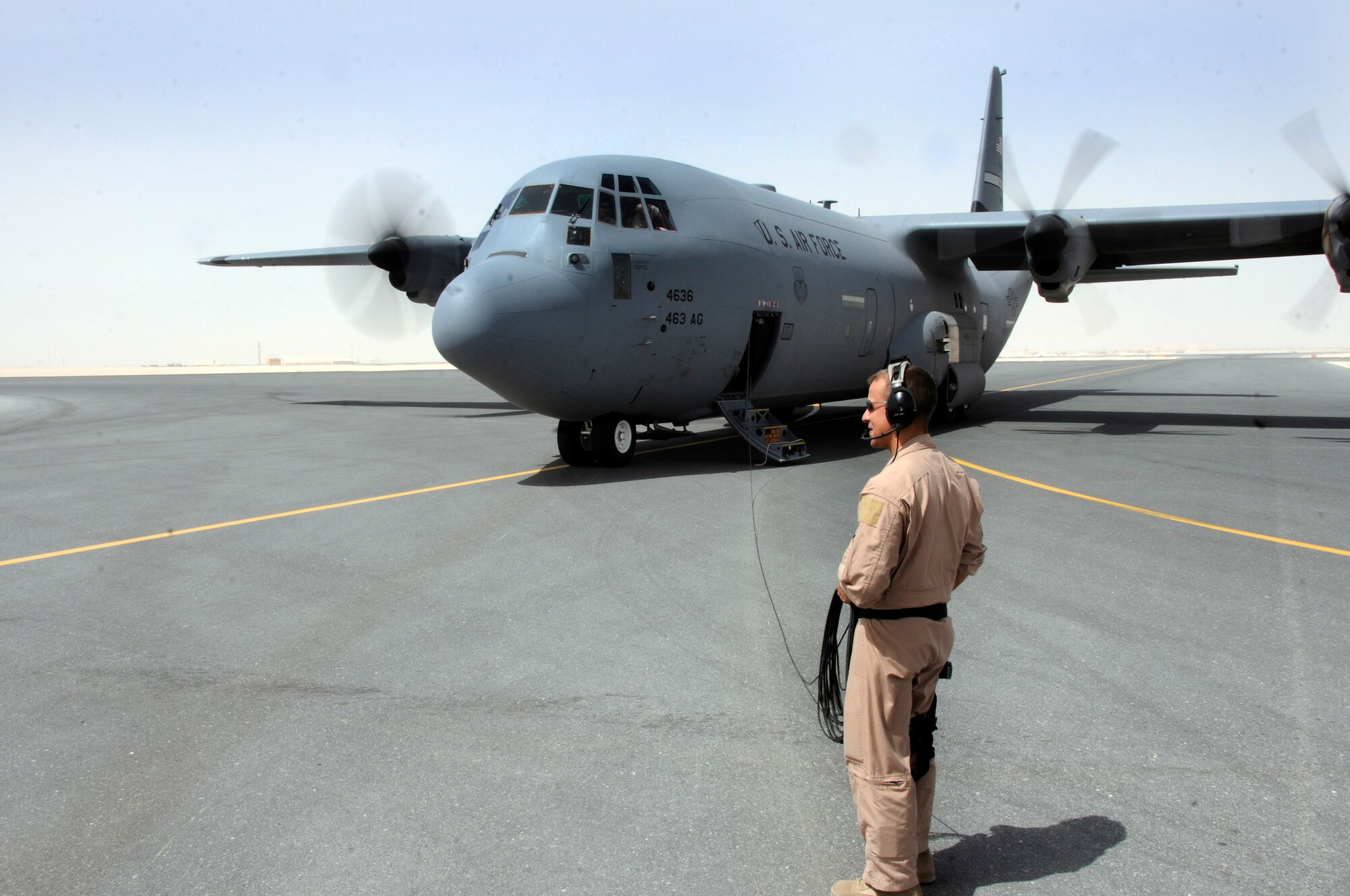 Staff Sgt. Frank Ventura, a loadmaster assigned to the 746th Expeditionary Airlift Squadron, acts as outside liaison to clear a C-130 Hercules after it landed because of an in-flight emergency October 3, 2008, at an undisclosed air base in Southwest Asia.  With help from maintenance personnel from the 746th Aircraft Maintenance Unit, the problem is cleared and the flight is allowed to continue.  The C-130 was originally designed as a troop, medical evacuation, and cargo transport aircraft. The versatile airframe has found uses in a variety of roles and humanitarian aid operations throughout the area of operations.  Sergeant Ventura, a native of Cleveland, Ohio, is deployed from Little Rock Air Force Base, Ark., in support of Operations Iraqi and Enduring Freedom and Joint Task Force-Horn of Africa.  (U.S. Air Force photo by Tech. Sgt. Michael Boquette/Released)