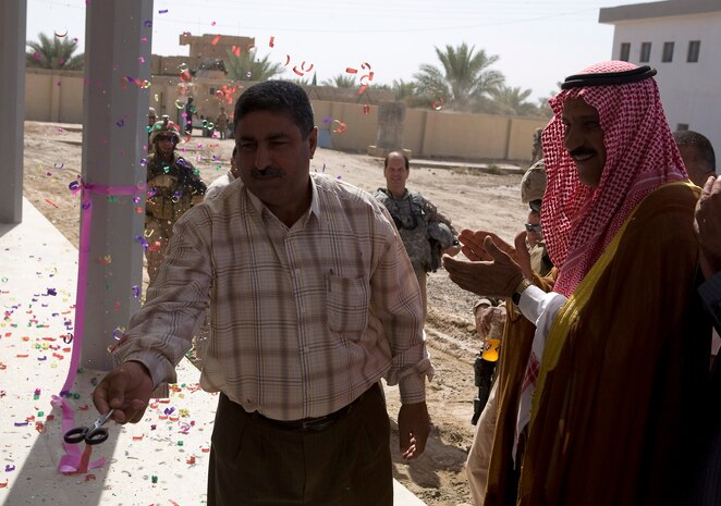 KARMAH, Iraq (October 5, 2008)-Mayor Faisal Hamad Khalaf cuts the ribbon at the reopening of al Shohabi Boys and Girls primary school, October 5, in Karmah. Hundreds, from sixth to 12th grade, will attend the school this fall. Marines from Task Force 1st Battalion, 3rd Marine Regiment, Regimental Combat Team 1, oversaw the reconstruction of the school. In an area with a roughly 20 percent literacy rate, Coalition forces view the struggling education system as a critical component in successfully rebuilding Iraq. (Photo by Lance Cpl. Achilles Tsantarliotis)