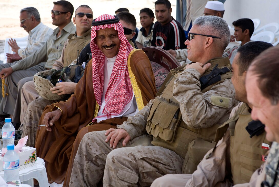 KARMAH, Iraq (October 5, 2008)-A sheik from the Shohabi tribe and Lt. Col. Andrew Milburn, commanding officer, Task Force 1st Battalion, 3rd Marine Regiment, Regimental Combat Team 1, talk about the Shohabi Boys and Girls primary school reopening and progress in the area. The school's reconstruction is a result of the progress of Iraqi security forces and security in Karmah. (Photo by Lance Cpl. Achilles Tsantarliotis)