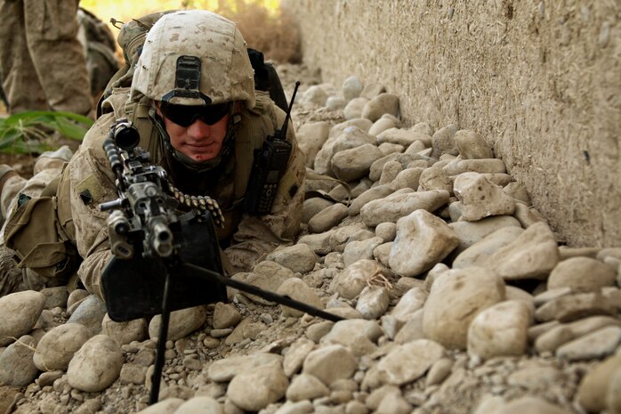 Lance Cpl. Joshua D. Mayor, a squad automatic weapon gunner assigned to Company E, TF 2/7 and Sand Springs, Okla., native, posts rear security while his fire team was stopped during a patrol near the Sangin District Center, Oct. 8.