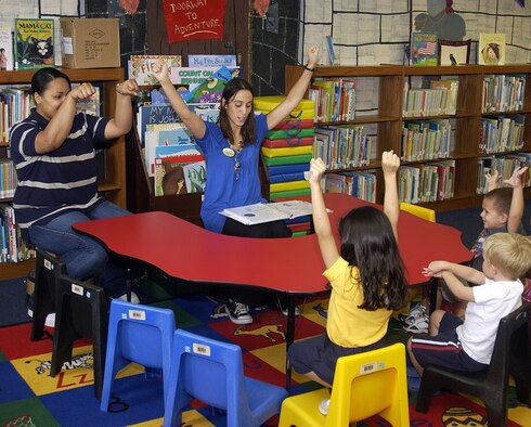 ANDERSEN AIR FORCE BASE, Guam - Christina Wray and Alicia Jackson, both librarian aides for the 36th Force Support Squadron, lead children in a rhyme with hand motions during Story Time at the Andersen Library Oct. 1. (U.S. Air Force photo by Airman 1st Class Carissa Wolff)                            