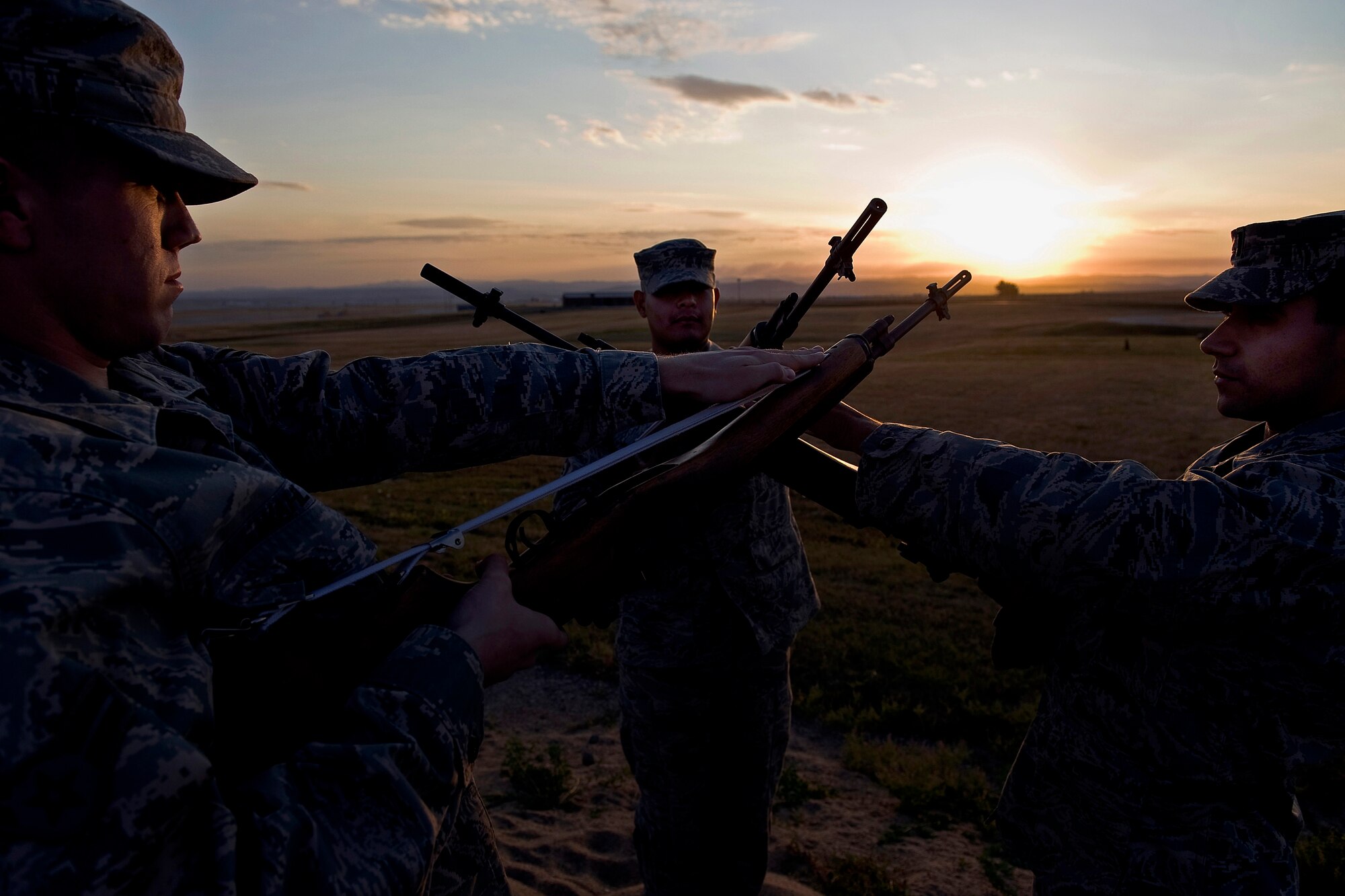 (From left) Airman 1st Class Ray Wahl, Staff Sgt. Ruben TrejoSanchez and 1st Lt. Erik Ruiz, Ellsworth Air Force Base Honor Guard Drill Team members, practice drill movements here, Oct. 3. The drill team is designed to inspire Air Force awareness among military and civilian audiences through its complex drill routine. (U.S. Air Force photo/Senior Airman Marc I. Lane)