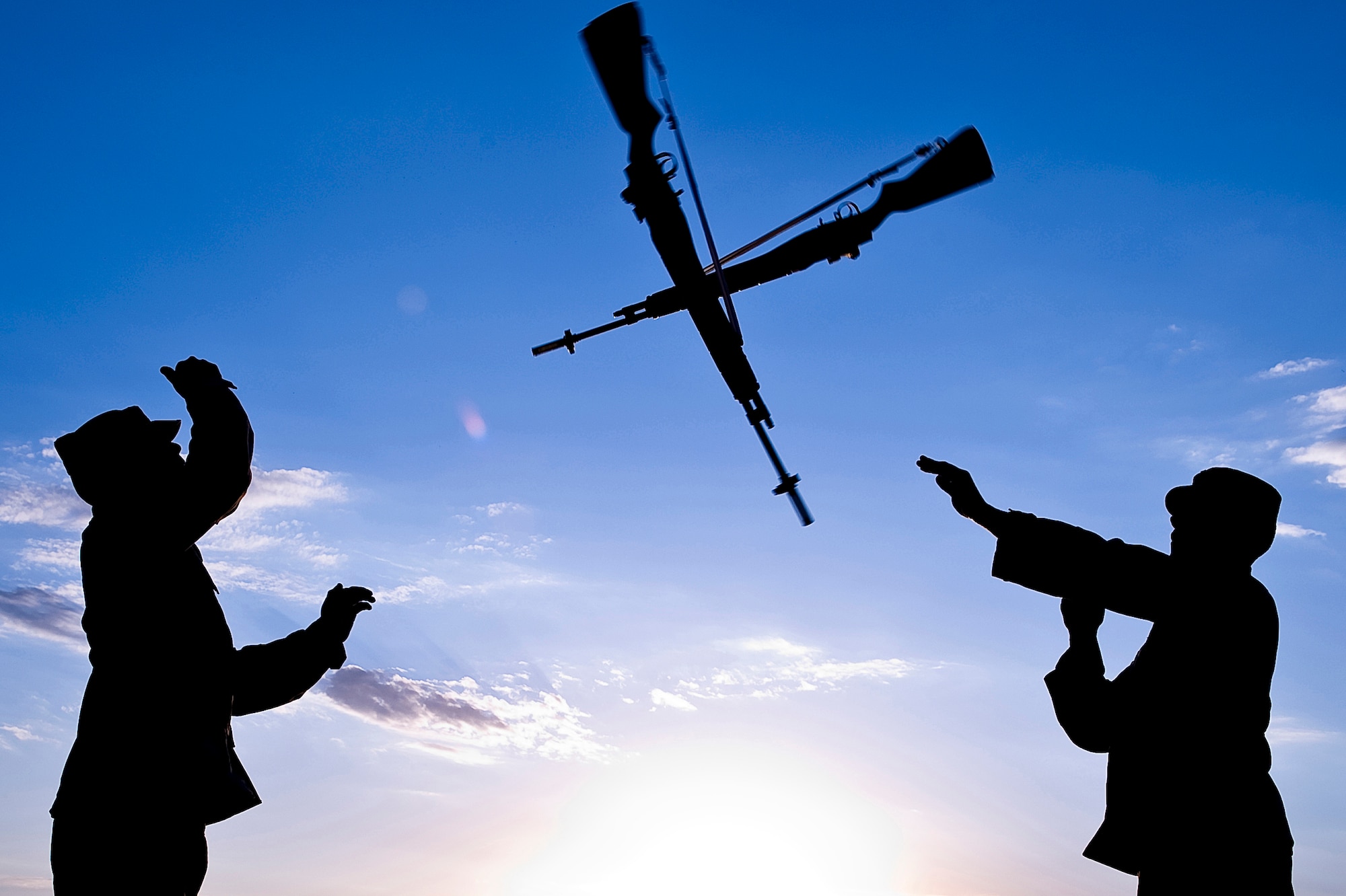 (Left) Staff Sgt. Ruben TrejoSanchez and 1st Lt. Erik Ruiz, Ellsworth Air Force Base Honor Guard Drill Team members, practice an over the head rifle toss here, Oct. 3. The drill team personifies the integrity, discipline, teamwork, and professionalism of every Airman. (U.S. Air Force photo/Senior Airman Marc I. Lane)